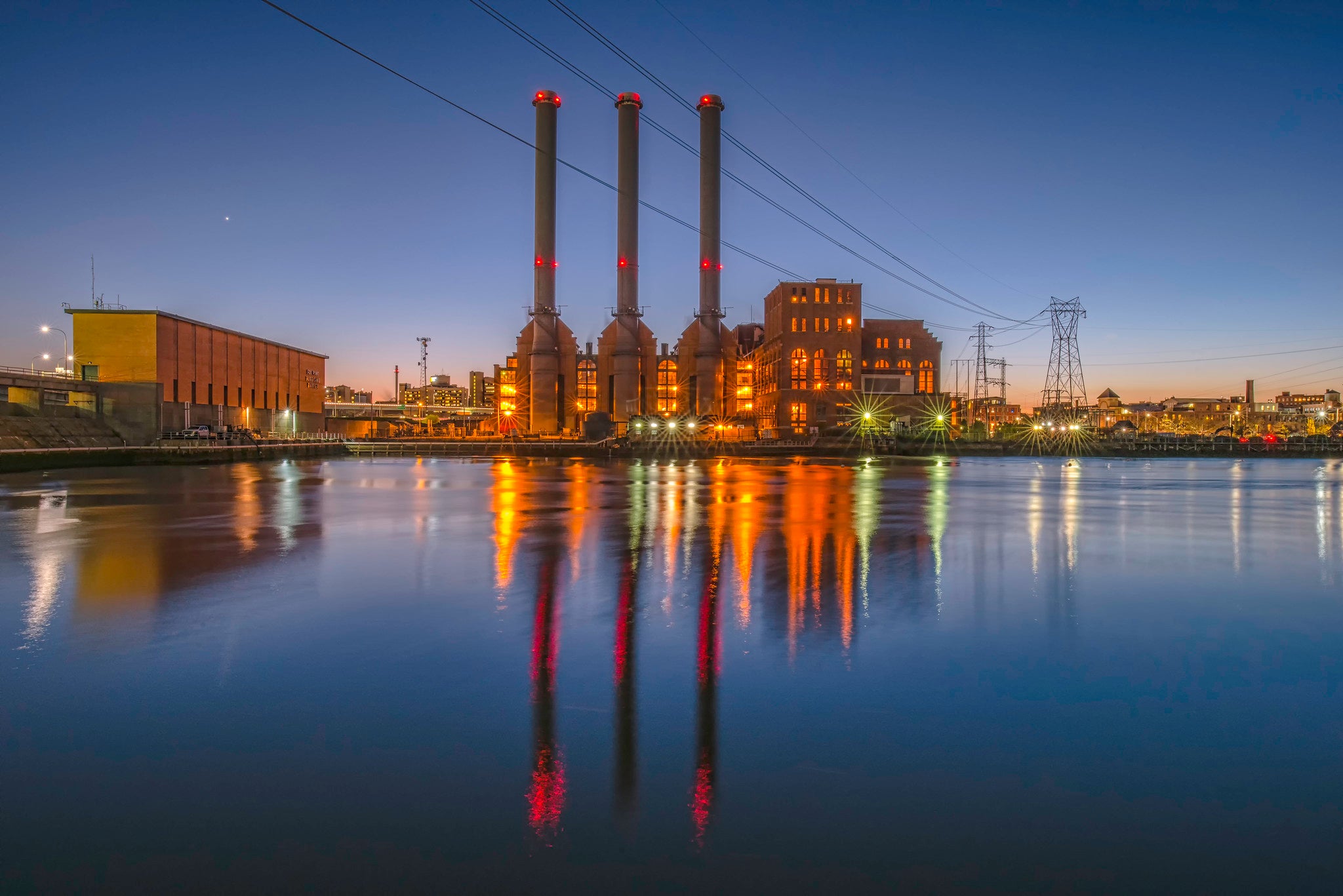 The three smokestacks of the Manchester Street power station at dusk