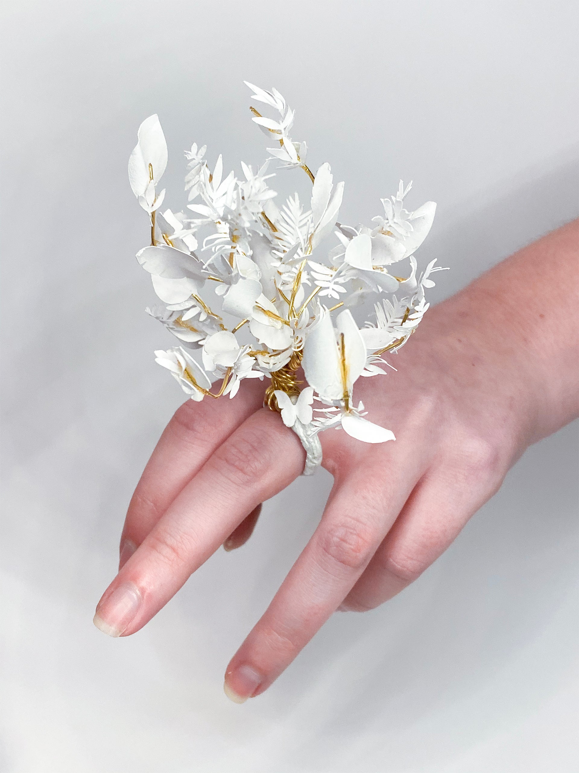 Hand with a sculptural floral ring made of paper and wire