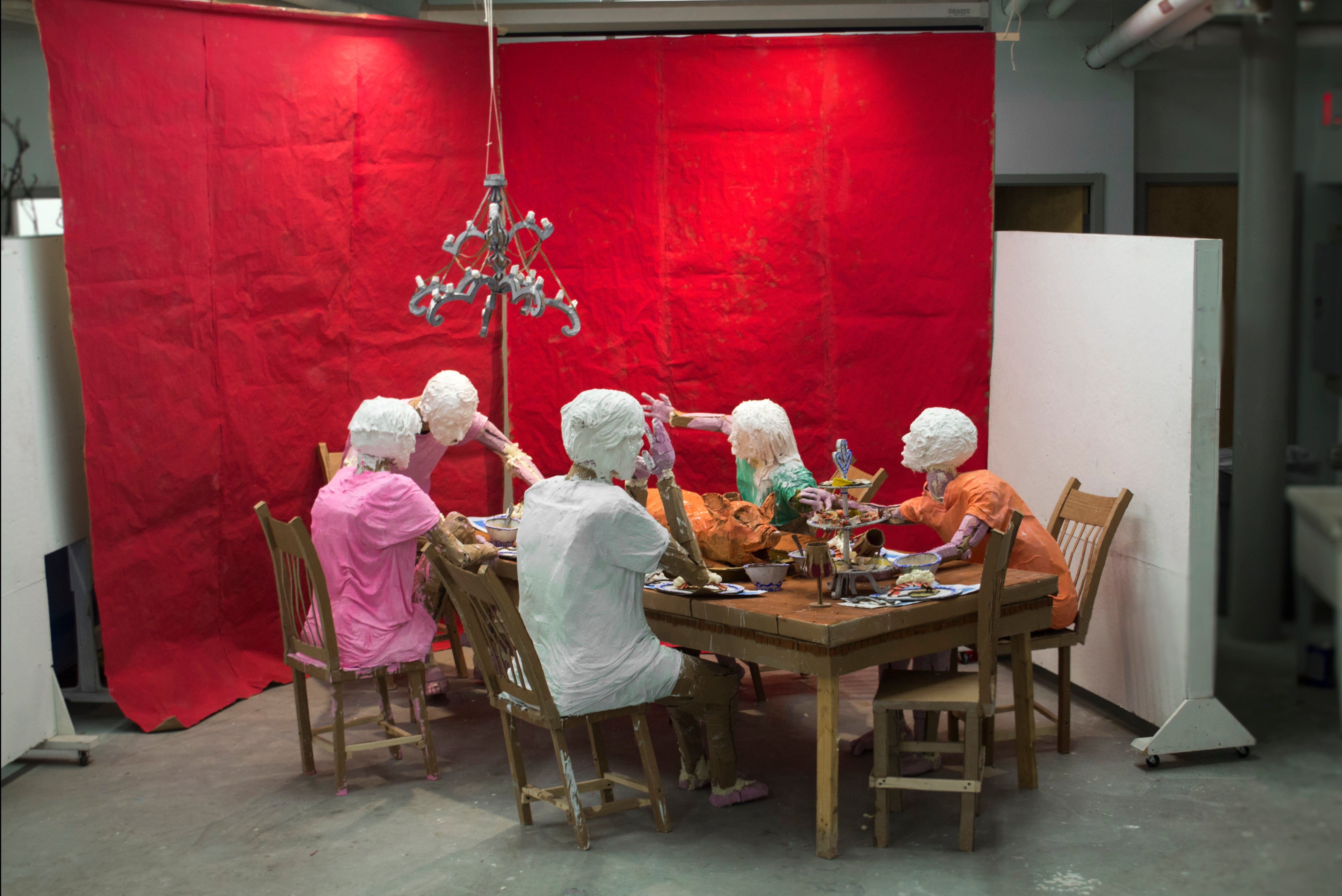 Installation of a group of people around a dinner table