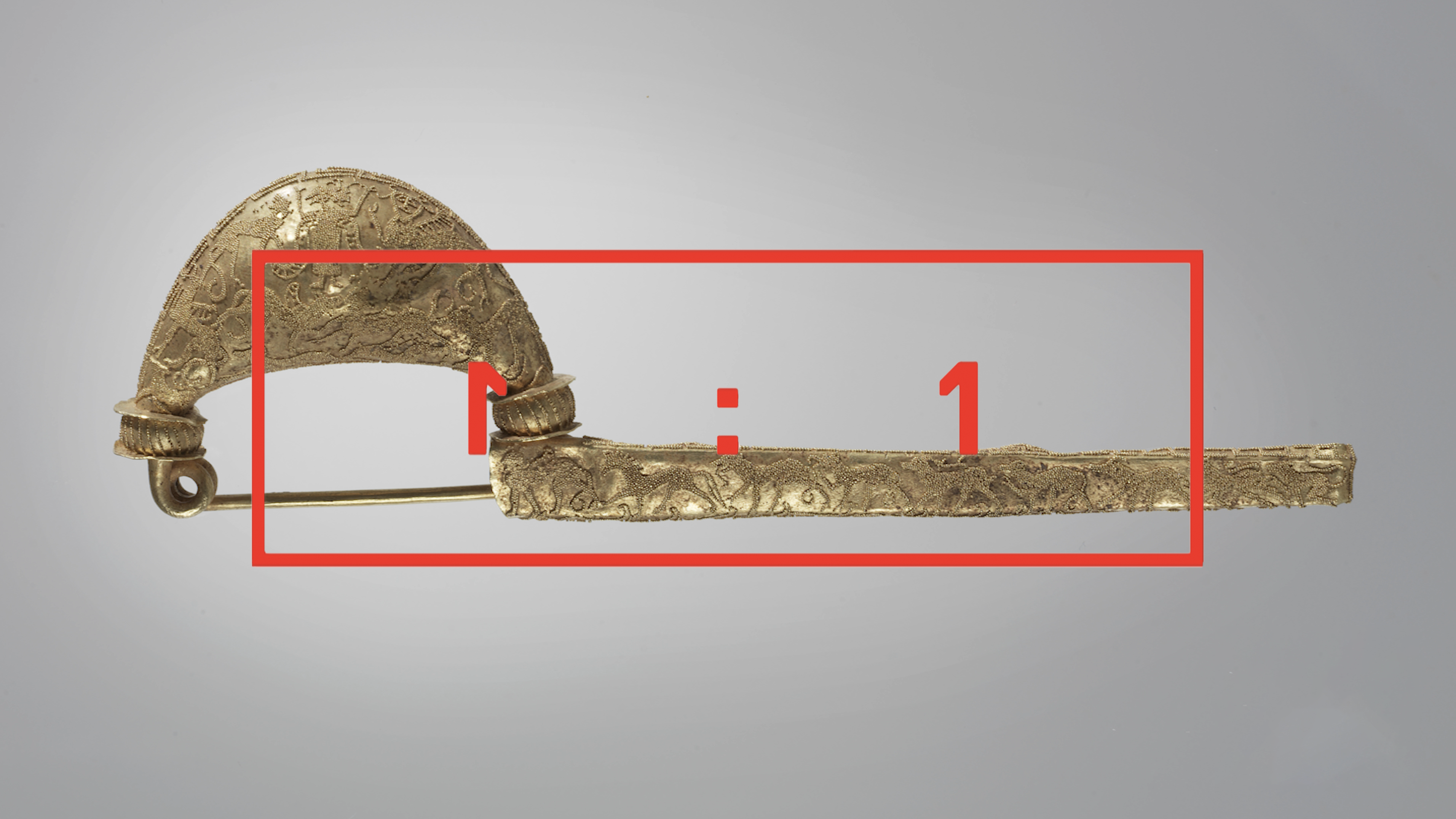 Video cover: a gold metal pin, rather like a fancy safety pin