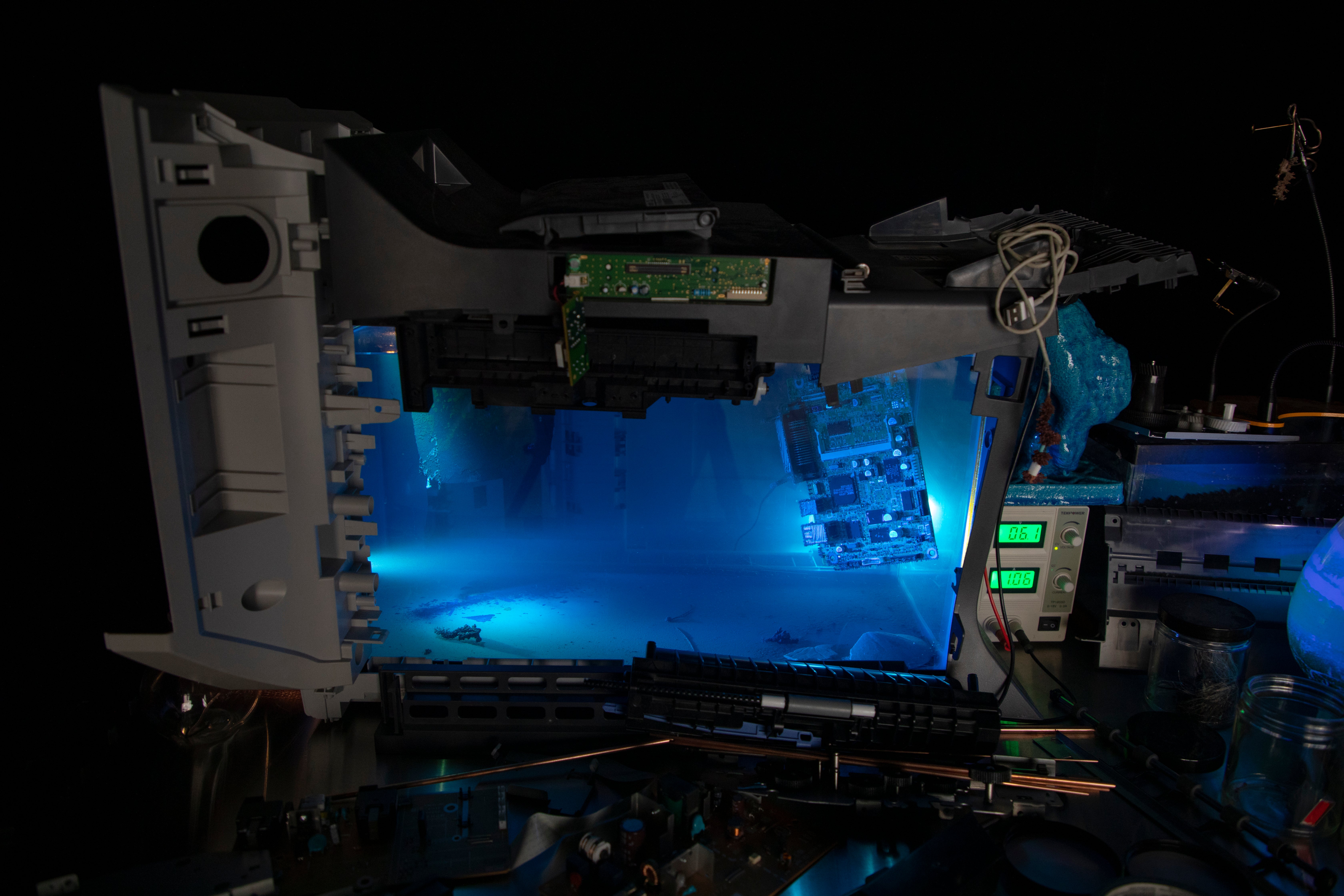 installation view, tank filled with blue liquid