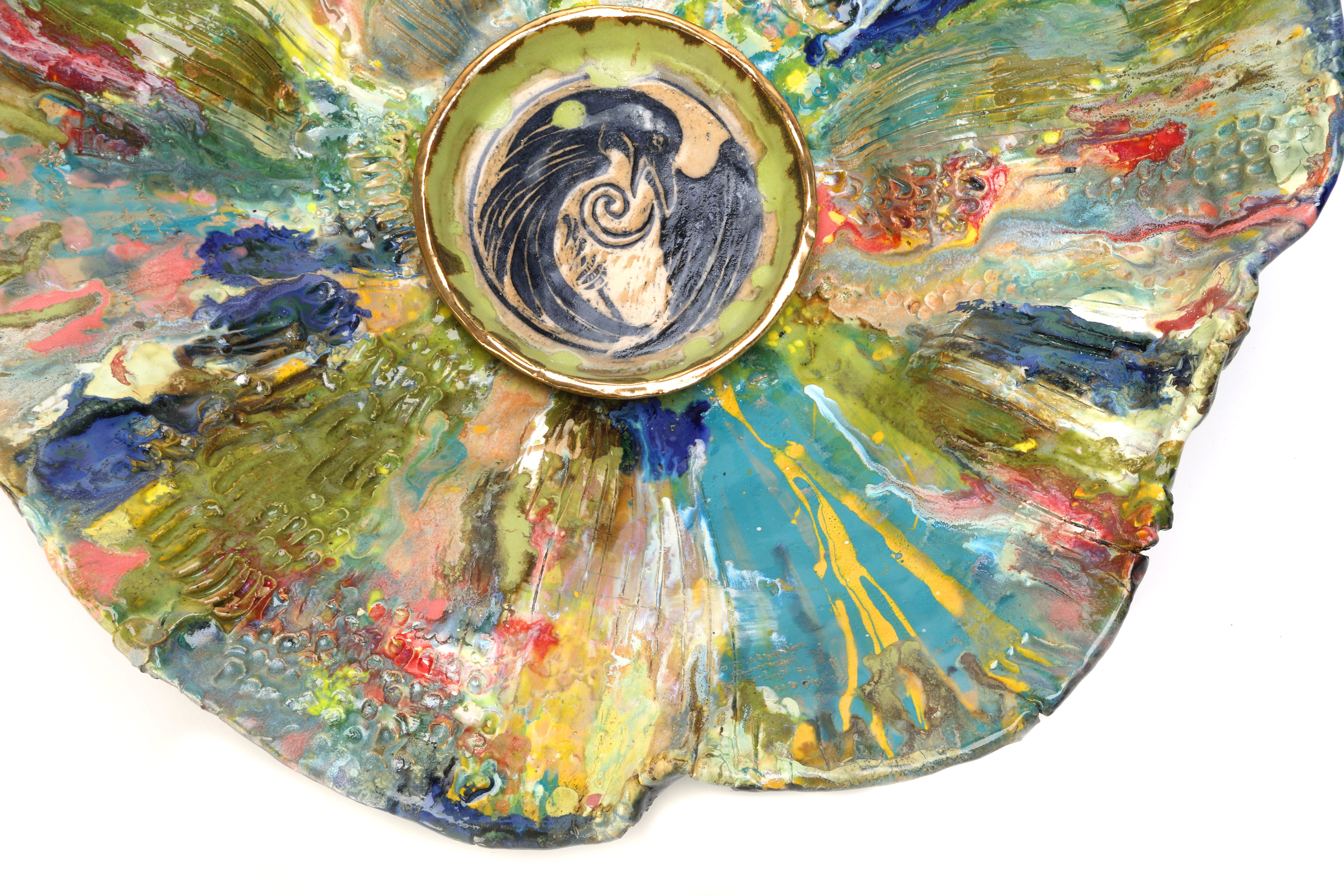 Colorful interior of large basin with illustration of raven in center. 