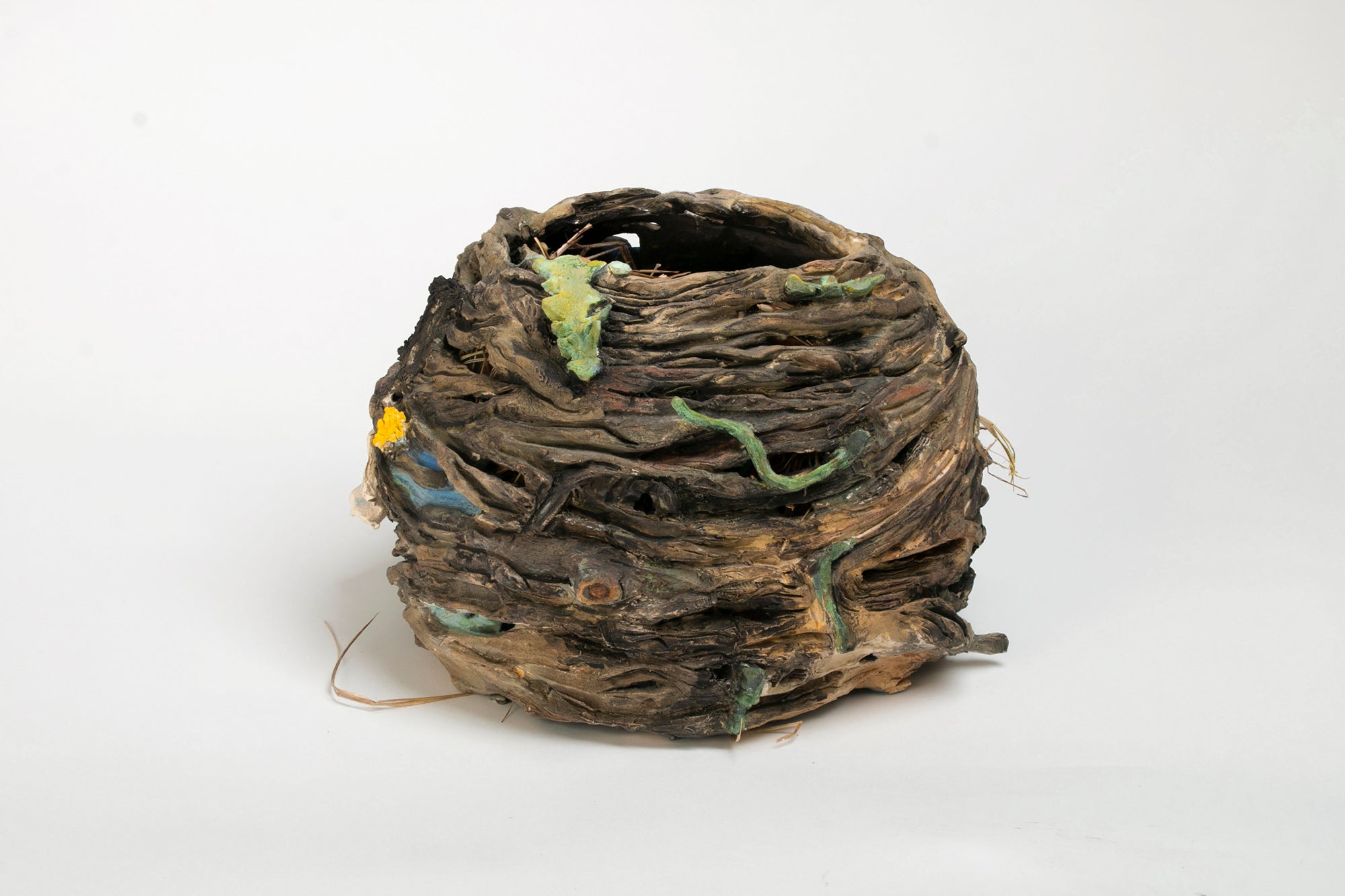 Ceramic nest sculpture with cattails and dandelions..