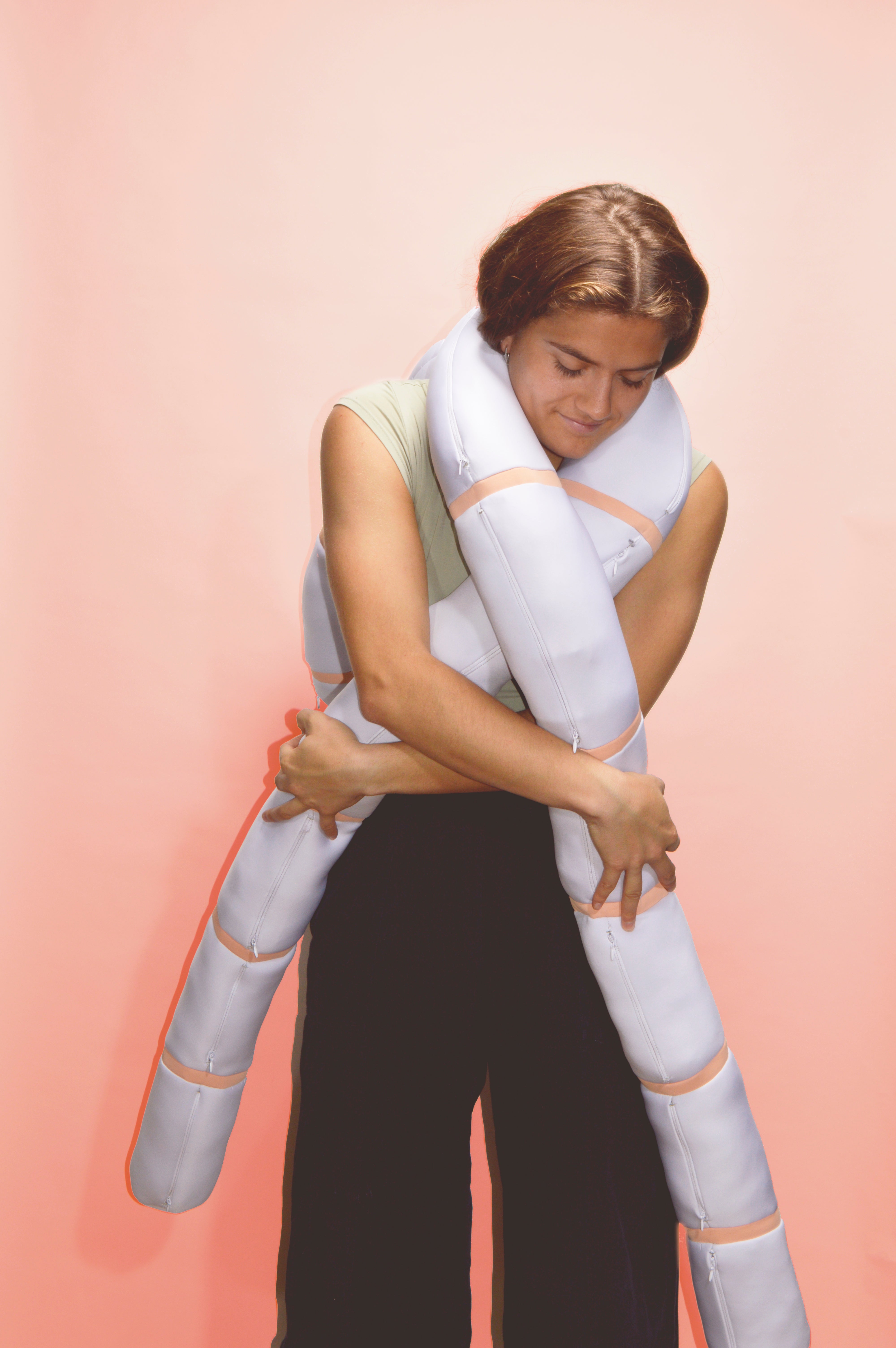 Color photograph, full body image with a girl holding Nudo in pink background