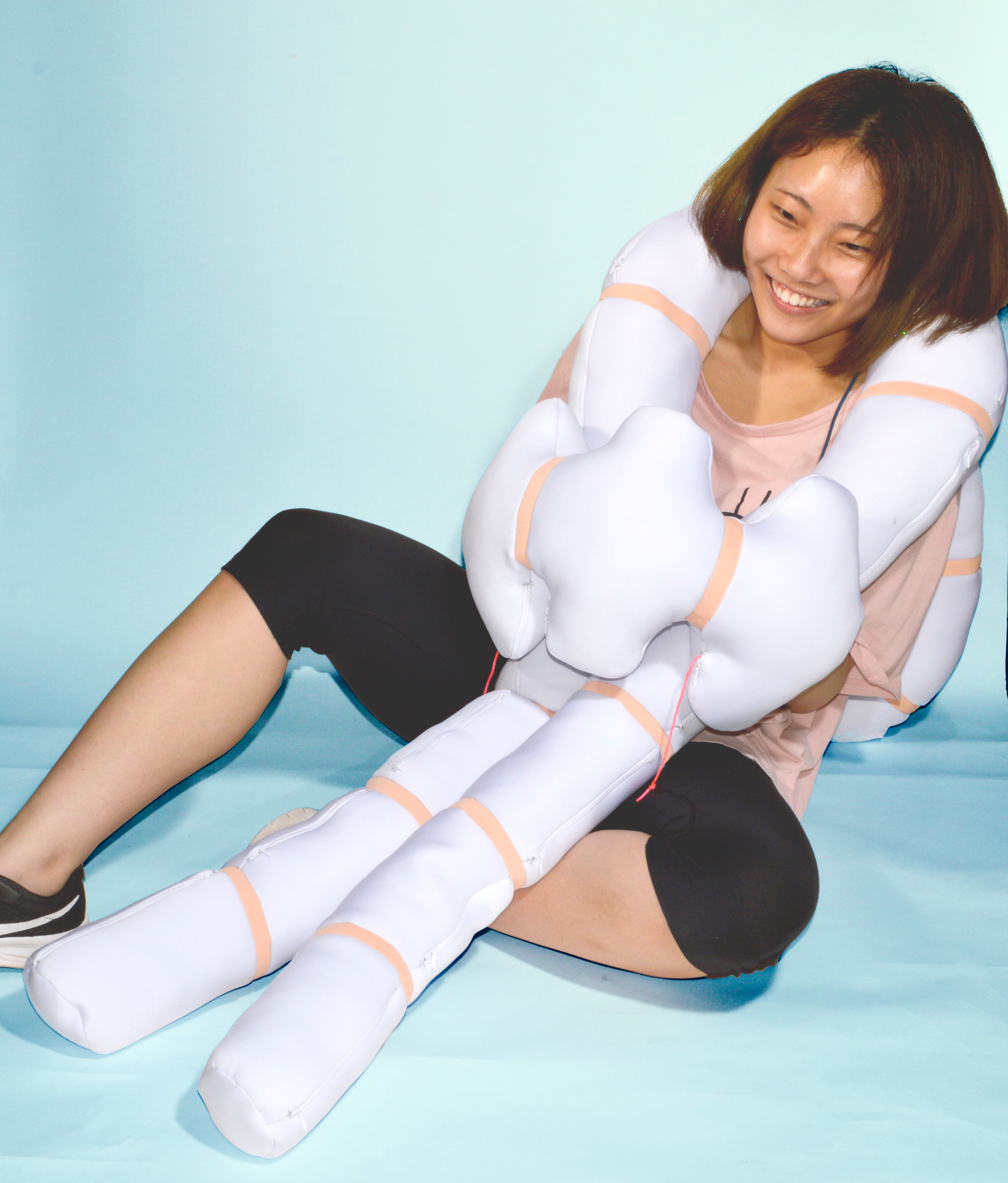 Color photograph, full body image with a girl playing with Nudo in blue background