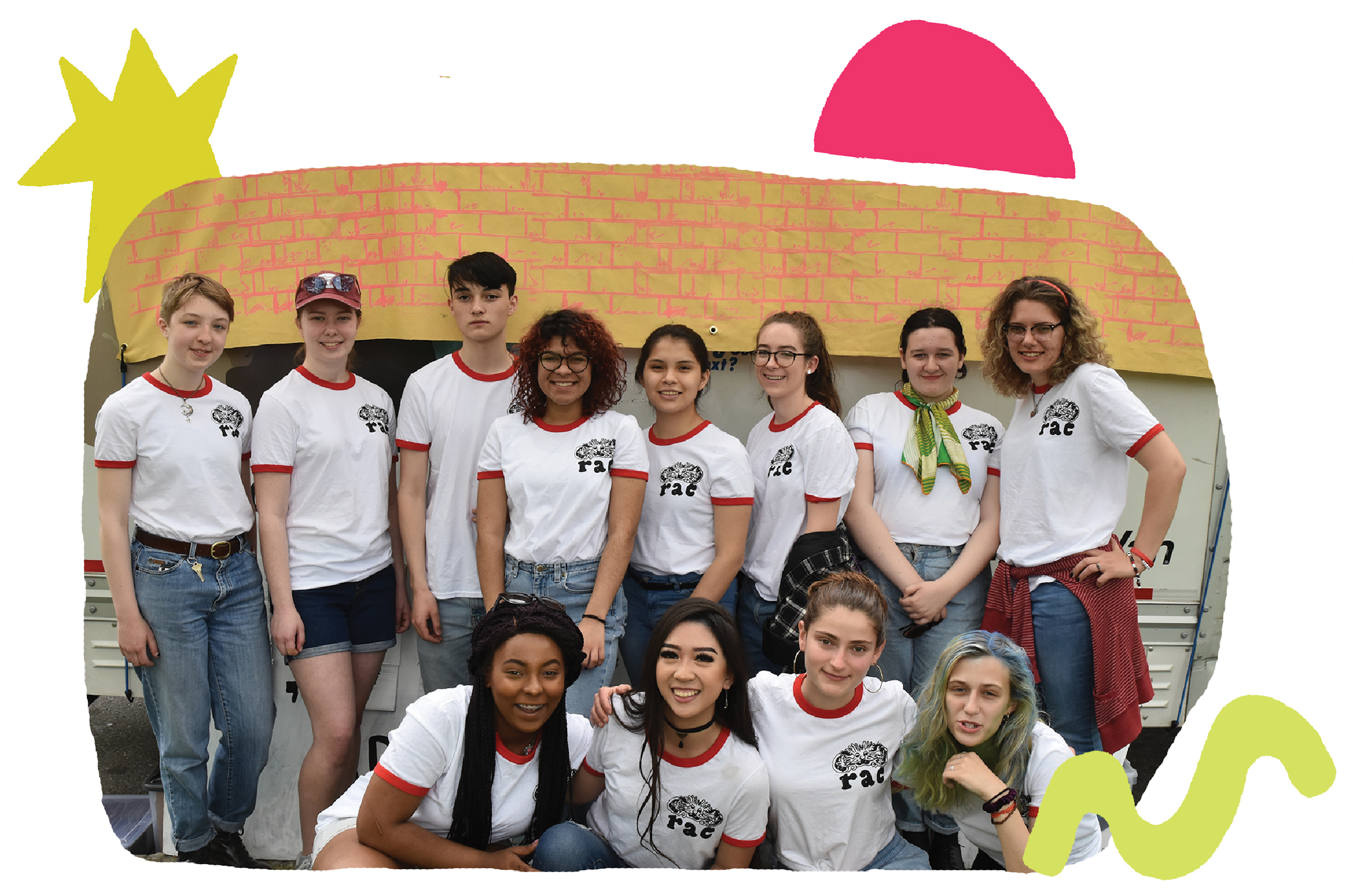 A group of twelve teens in matching white shirts poses happily in two rows.