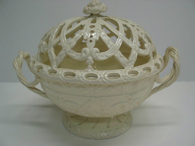 /A%20creamware%20chestnut%20basket%20with%20sculptural%20woven%20handles%2C%20sculpted%20foot%2C%20and%20the%20lid%20has%20decorative%20cutouts.%20