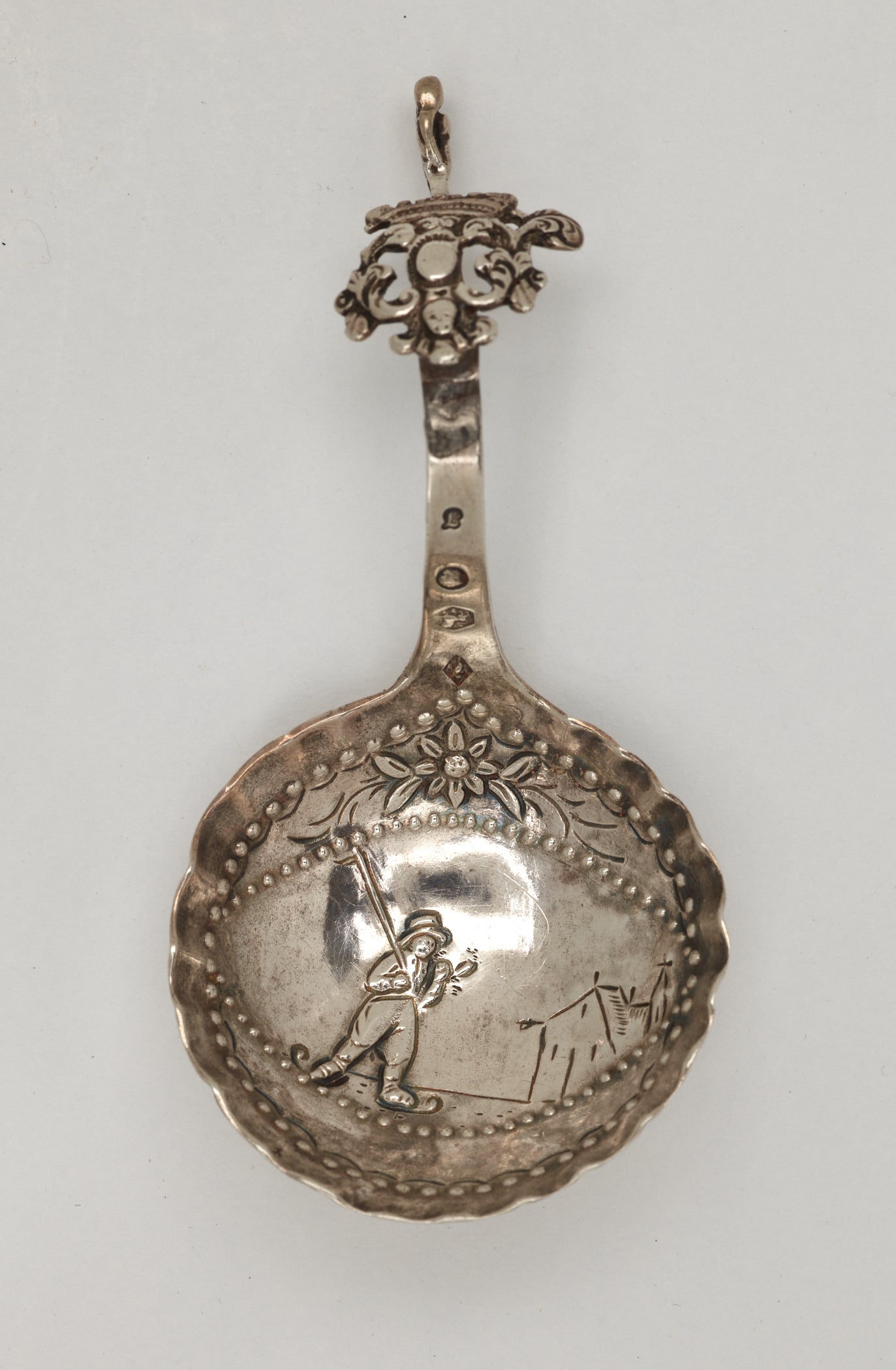 /A%20silver%20caddy%20spoon%20with%20figurative%20and%20sculptural%20elements.