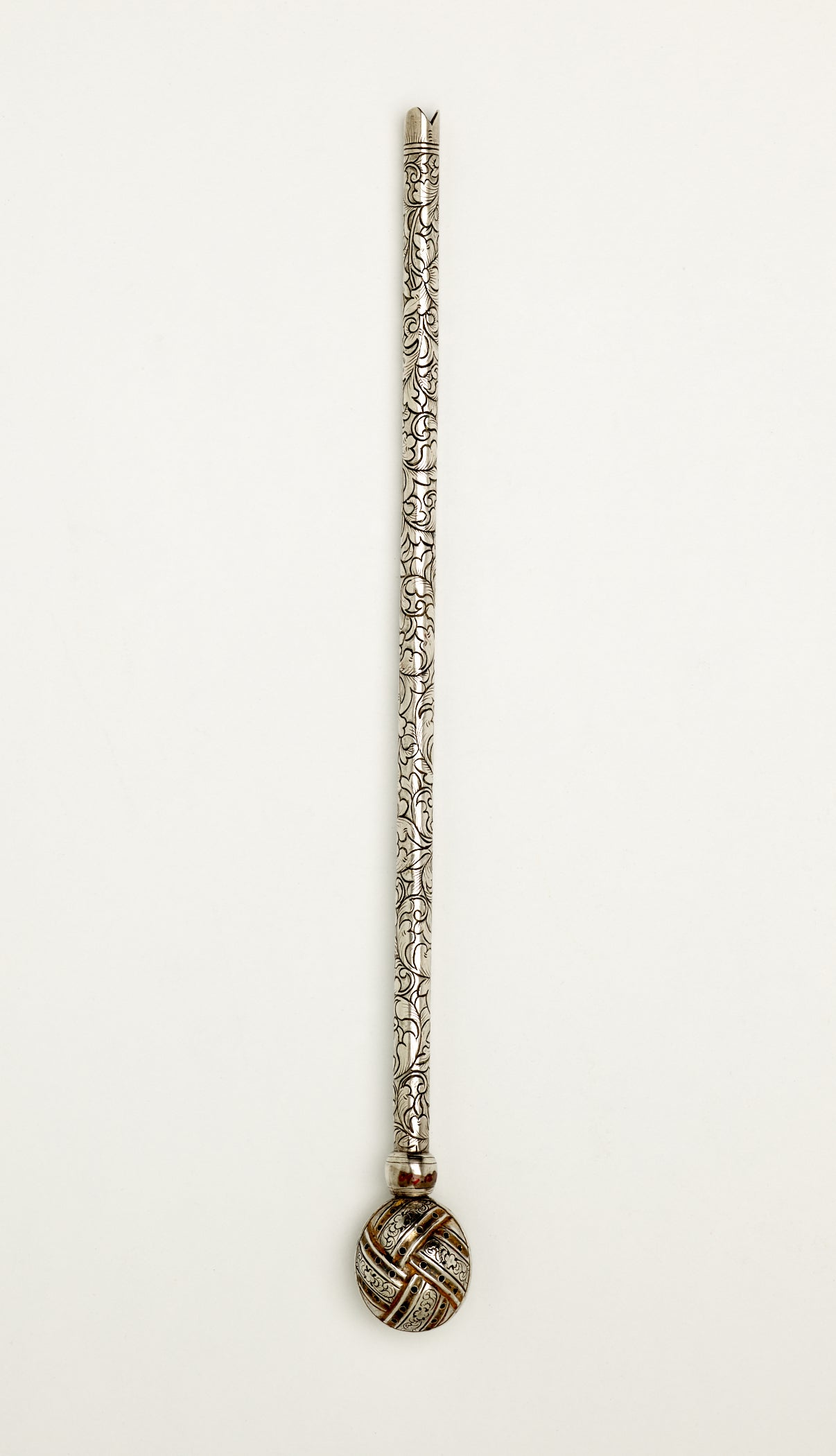 /A%20long%20silver%20utensil%20used%20for%20tea%20with%20a%20decorative%20body%20and%20has%20one%20small%20bulbous%20end.
