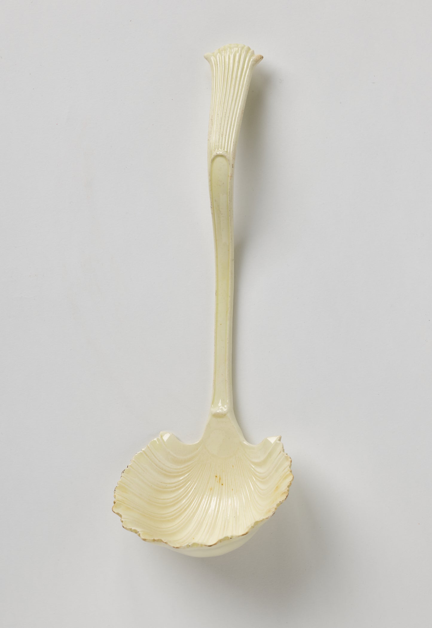 /A%20creamware%20ladle%20with%20a%20shell%20shaped%20bowl%20and%20simple%20necked%20handle%20that%20comes%20to%20a%20flared%20out%20point%20with%20linear%20decorations.%20