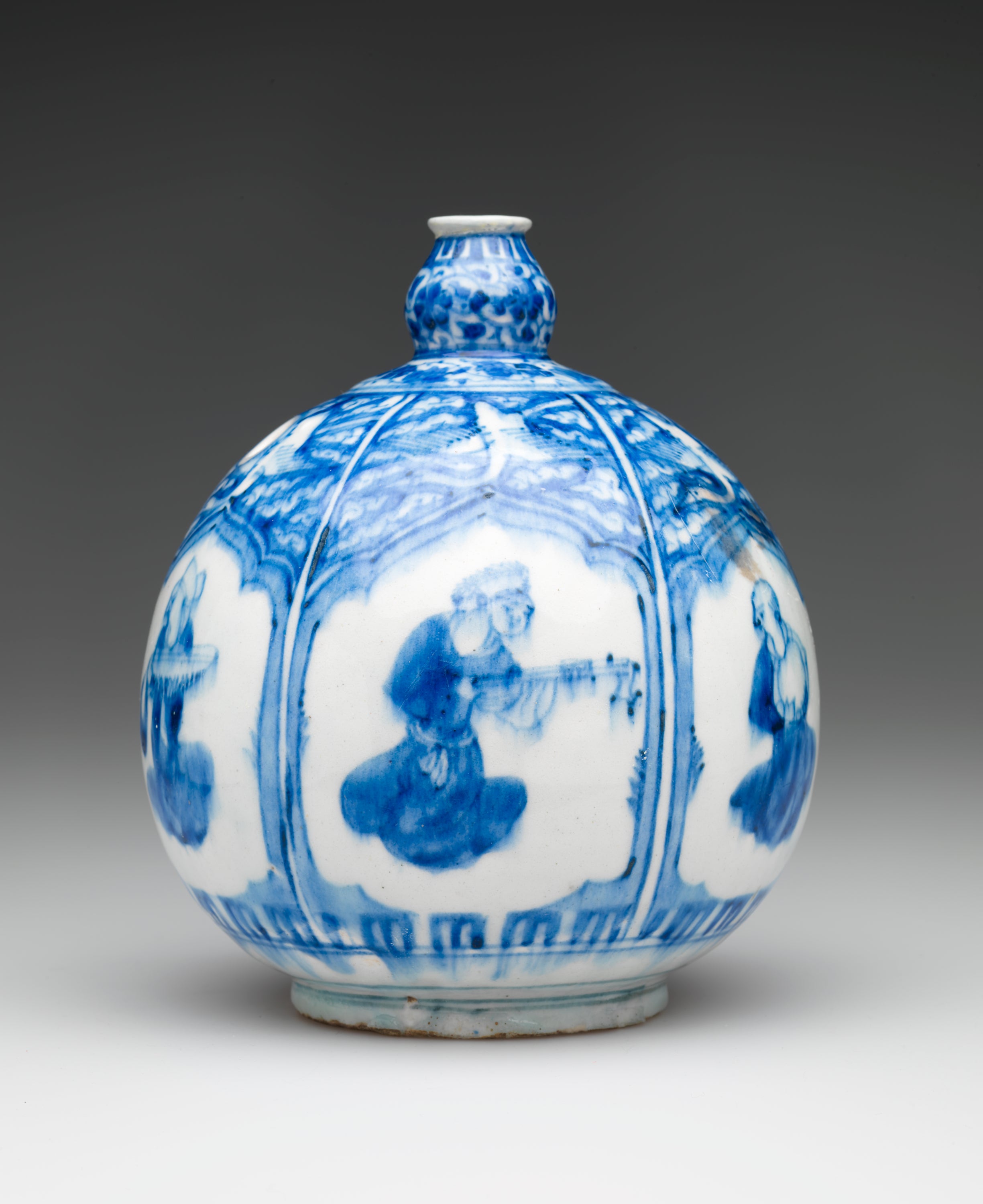 /A%20bulbous%20white%20and%20blue%20vessel%20with%20a%20small%20neck%20and%20a%20hole%20on%20the%20side.%20There%20is%20a%20repeating%20window%20shape%20with%20different%20figures%20inside%20the%20vignet.%20