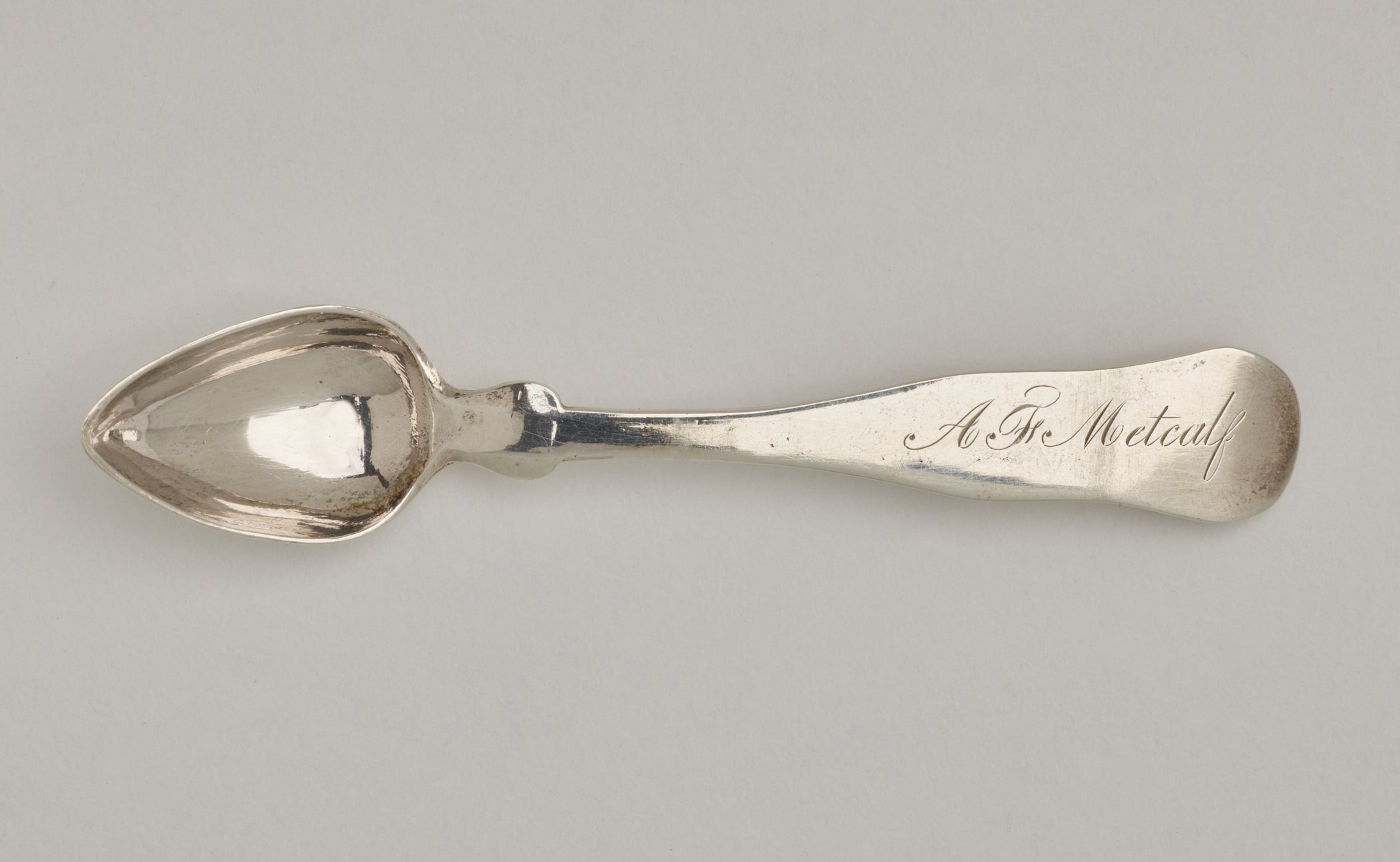 /%20A%20silver%20salt%20spoon%20the%20bowl%20comes%20to%20a%20pointed%20tip%2C%20the%20neck%20is%20thin%2C%20and%20the%20handle%20is%20thicker%20and%20rounded%20at%20the%20end.%20