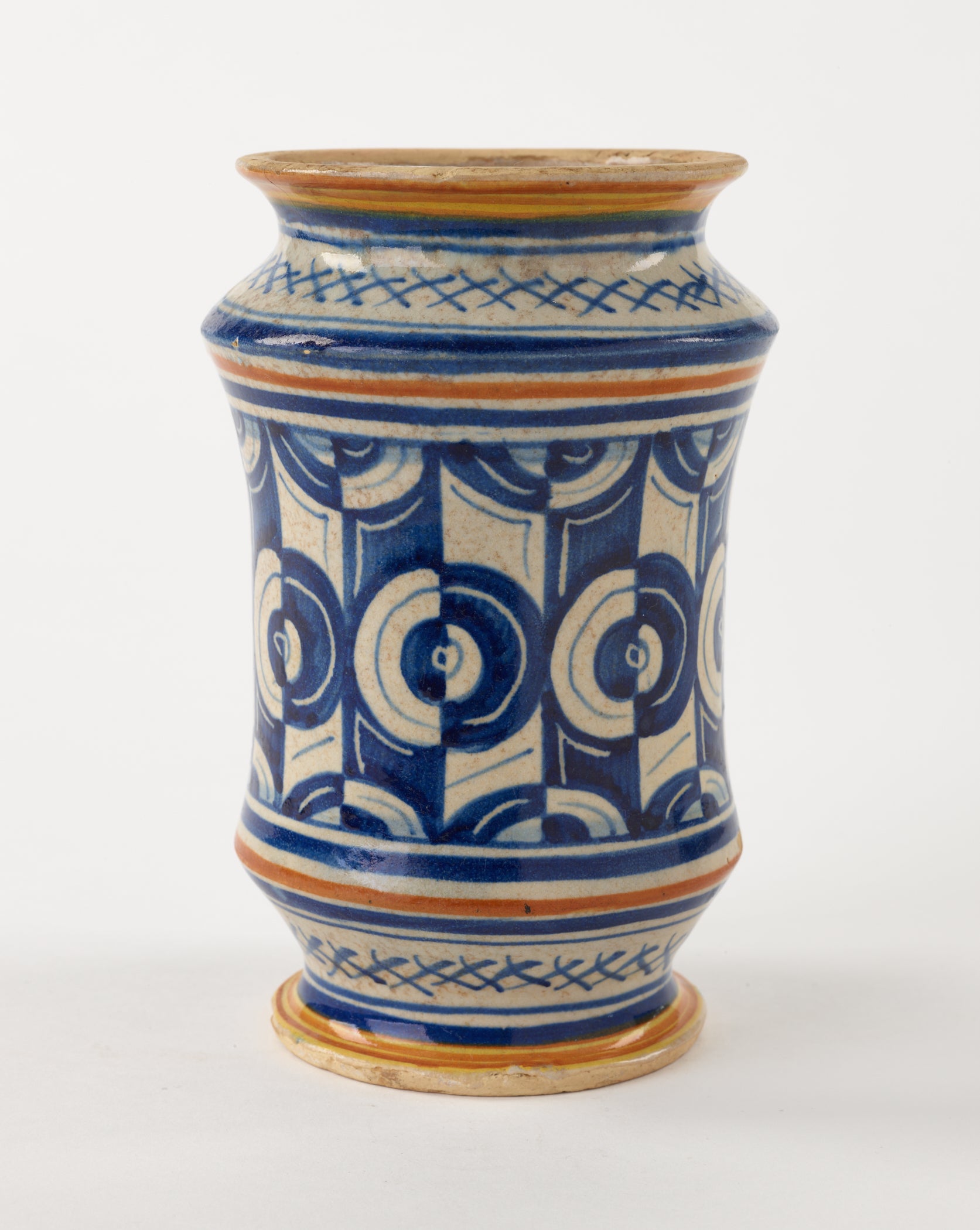 /A%20tin-glazed%20earthenware%20jar%20that%20has%20white%2C%20orange%2C%20and%20blue%20symmetrical%20decorations.