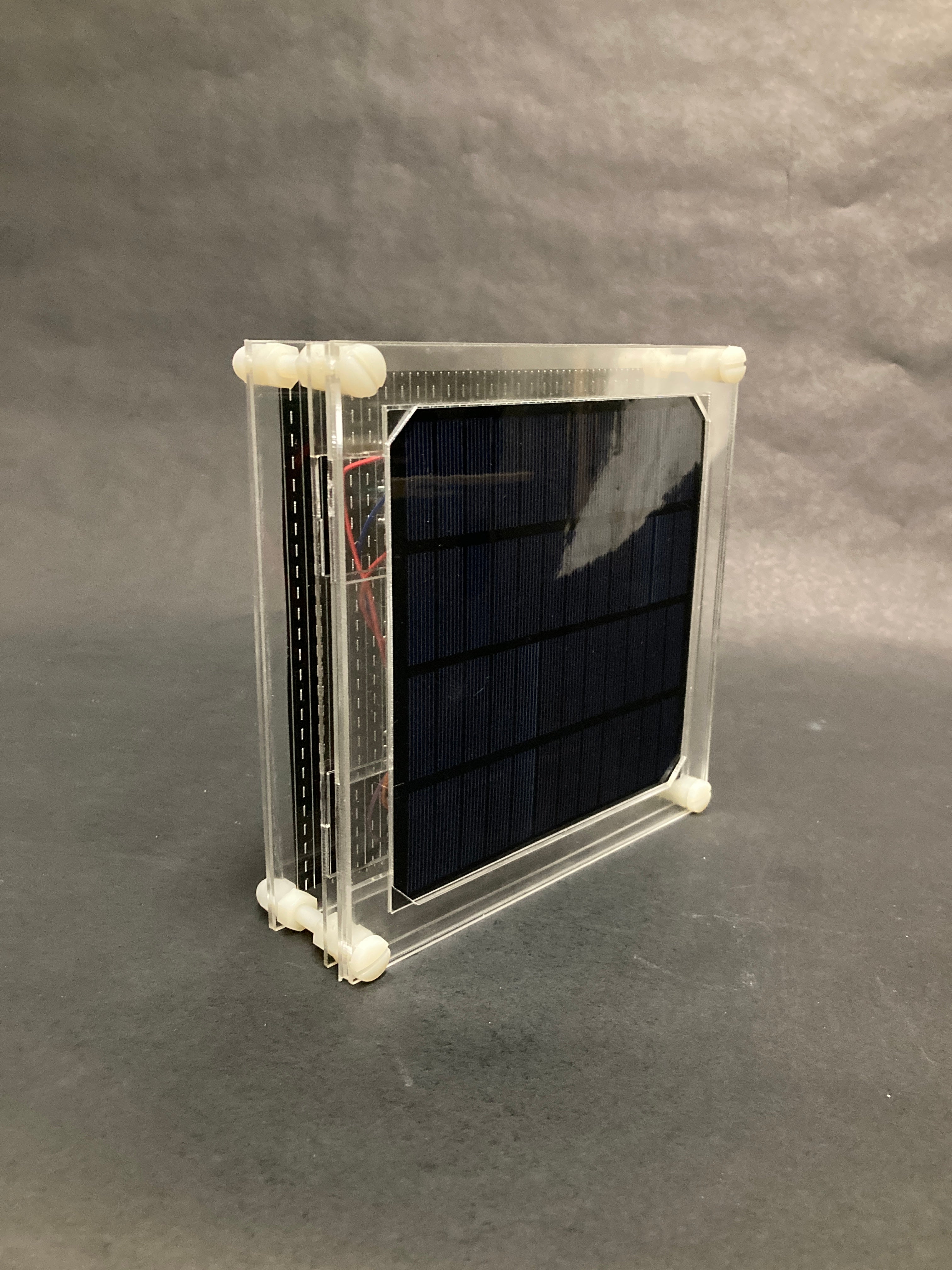 A framed solar cell, sitting on the table.
