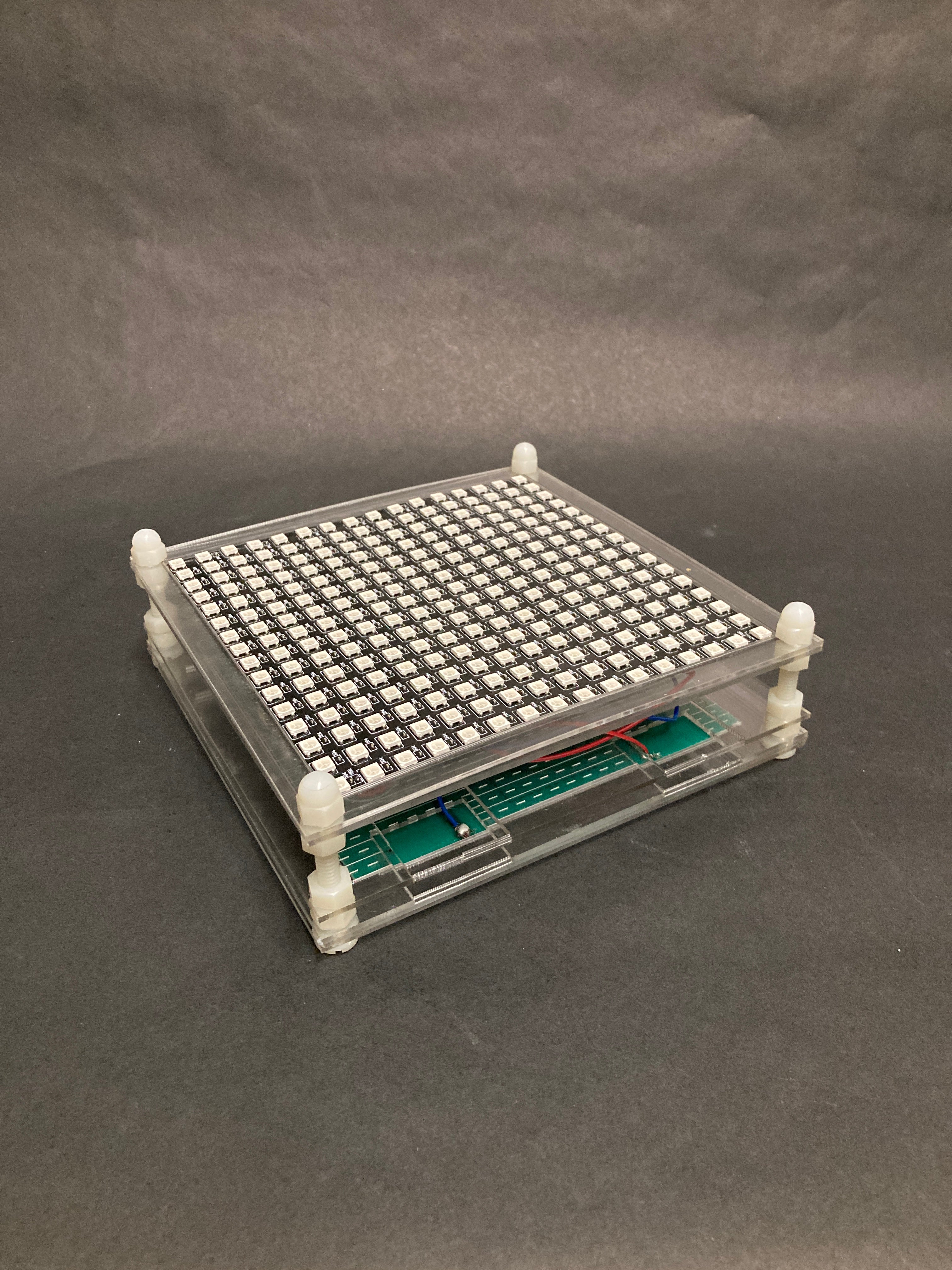 The acrylic frame holding a LED matrix facing up.