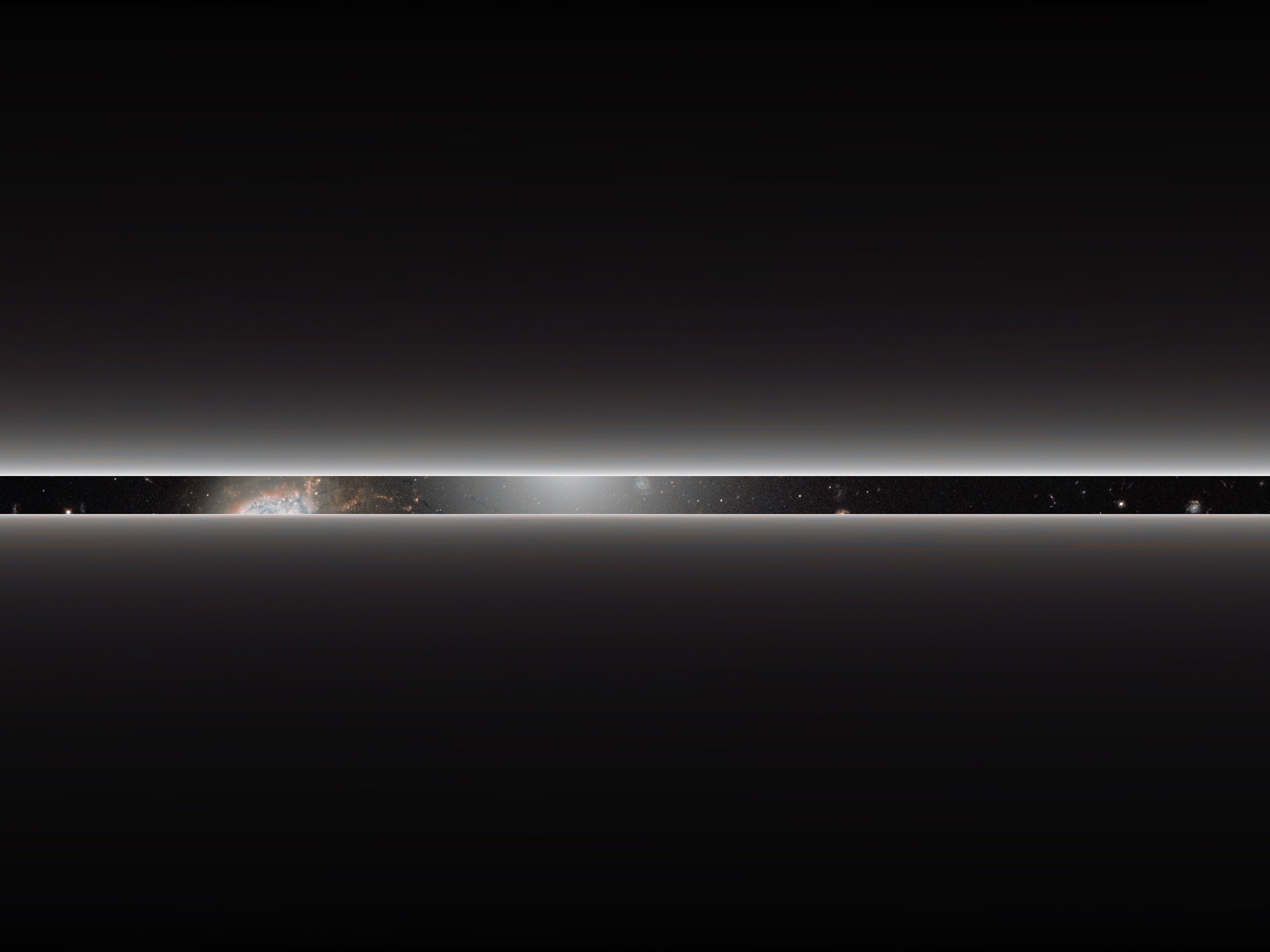 A dense band of stars between two light beams.