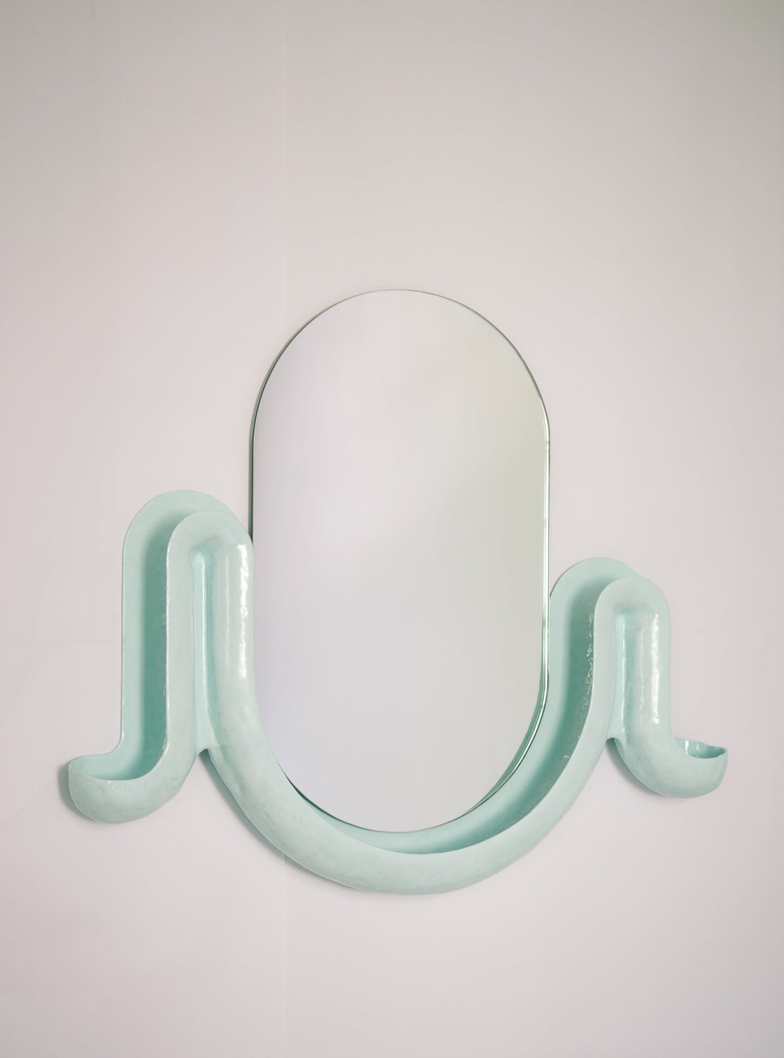 Two blue swell with a racetrack shaped mirror in the middle.