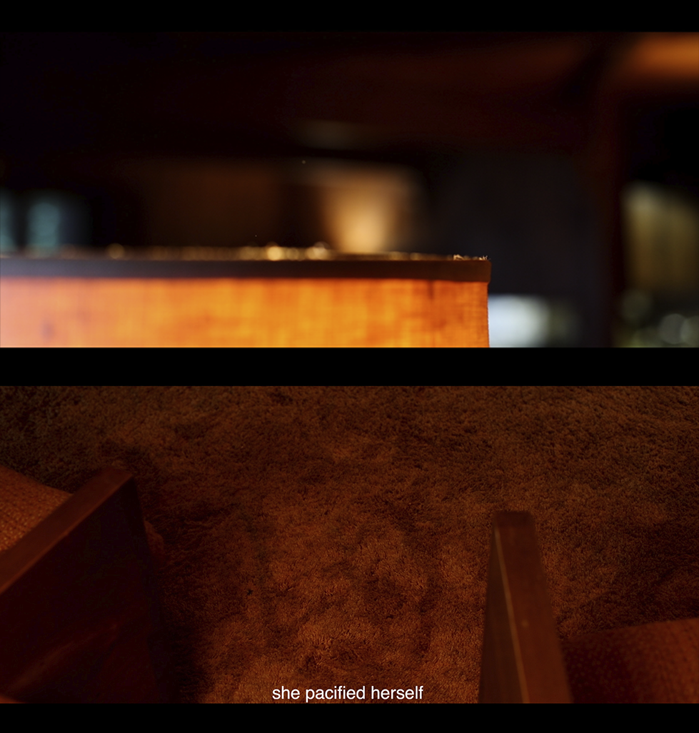 Two arm chairs on the edge of the frame sitting on top of an orange shag carpet. The top of an out of focus orange lamp with dust floating up.