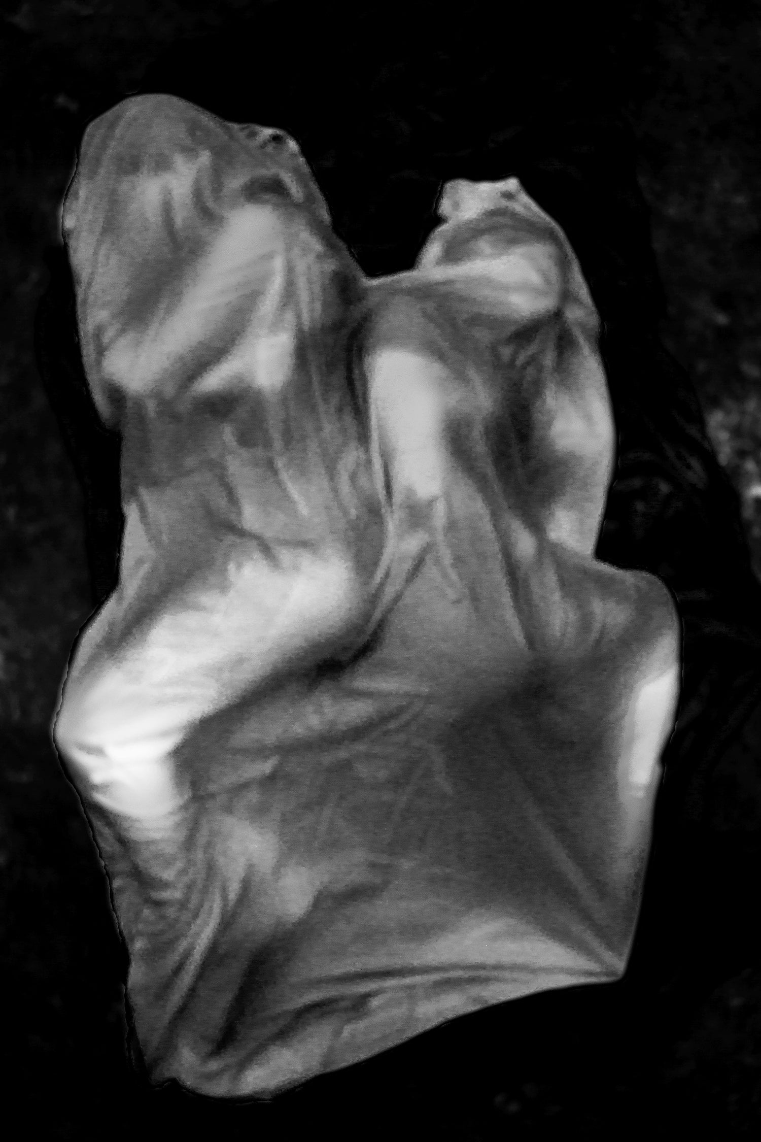 Two figures draped in fabric facing away from each other.