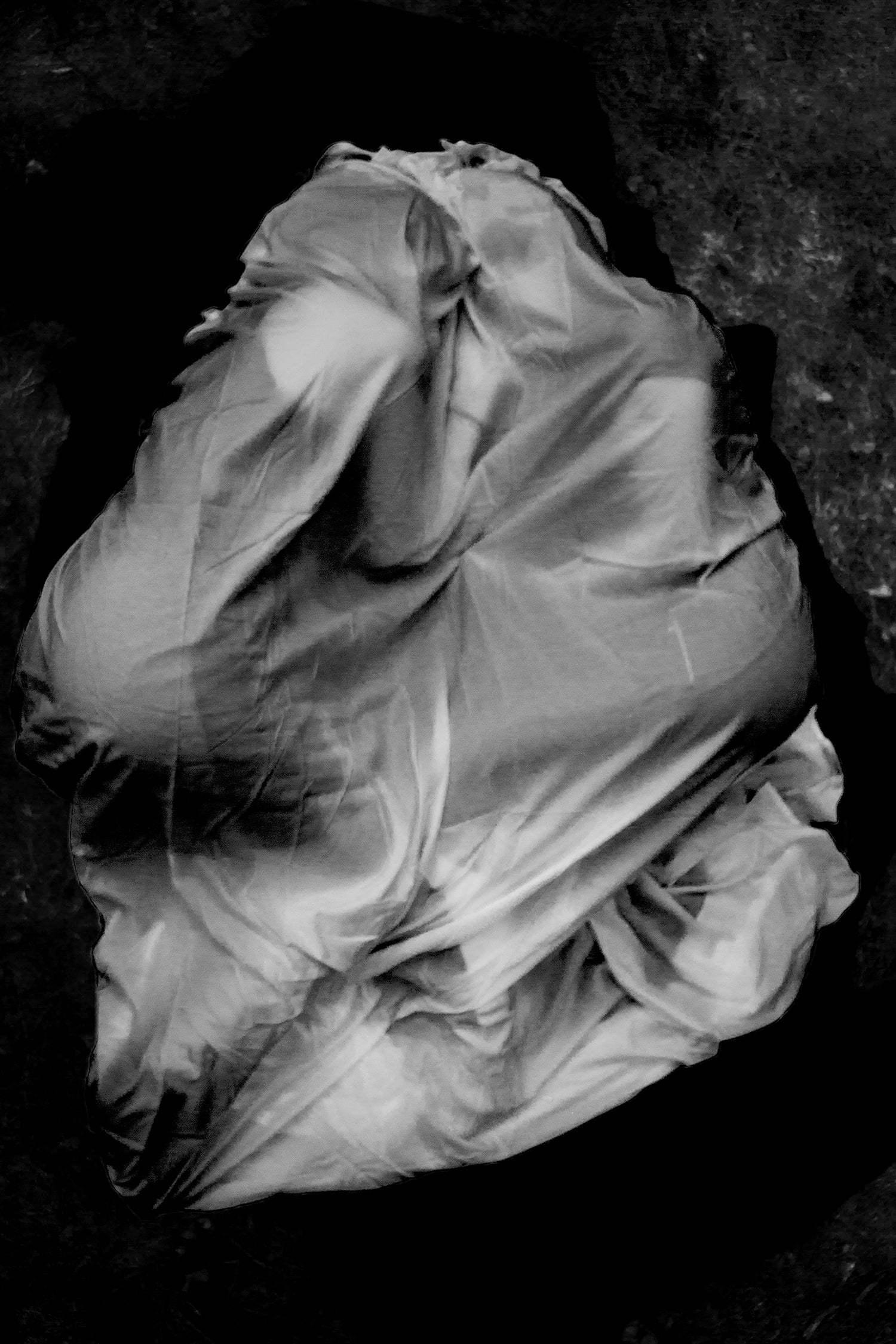 Two figures draped in fabric facing towards each other.