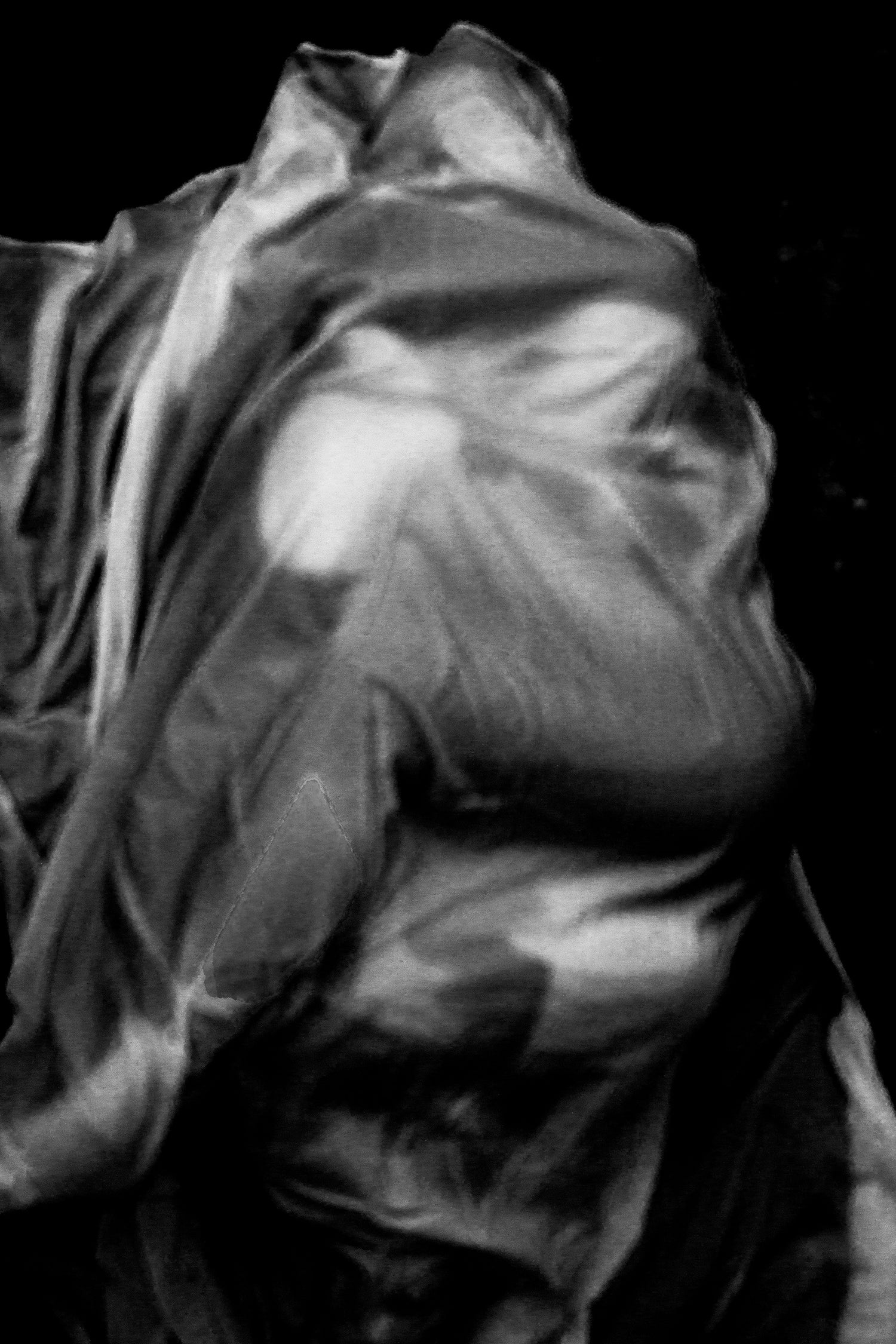 Two figures draped in fabric wrapping around each other.
