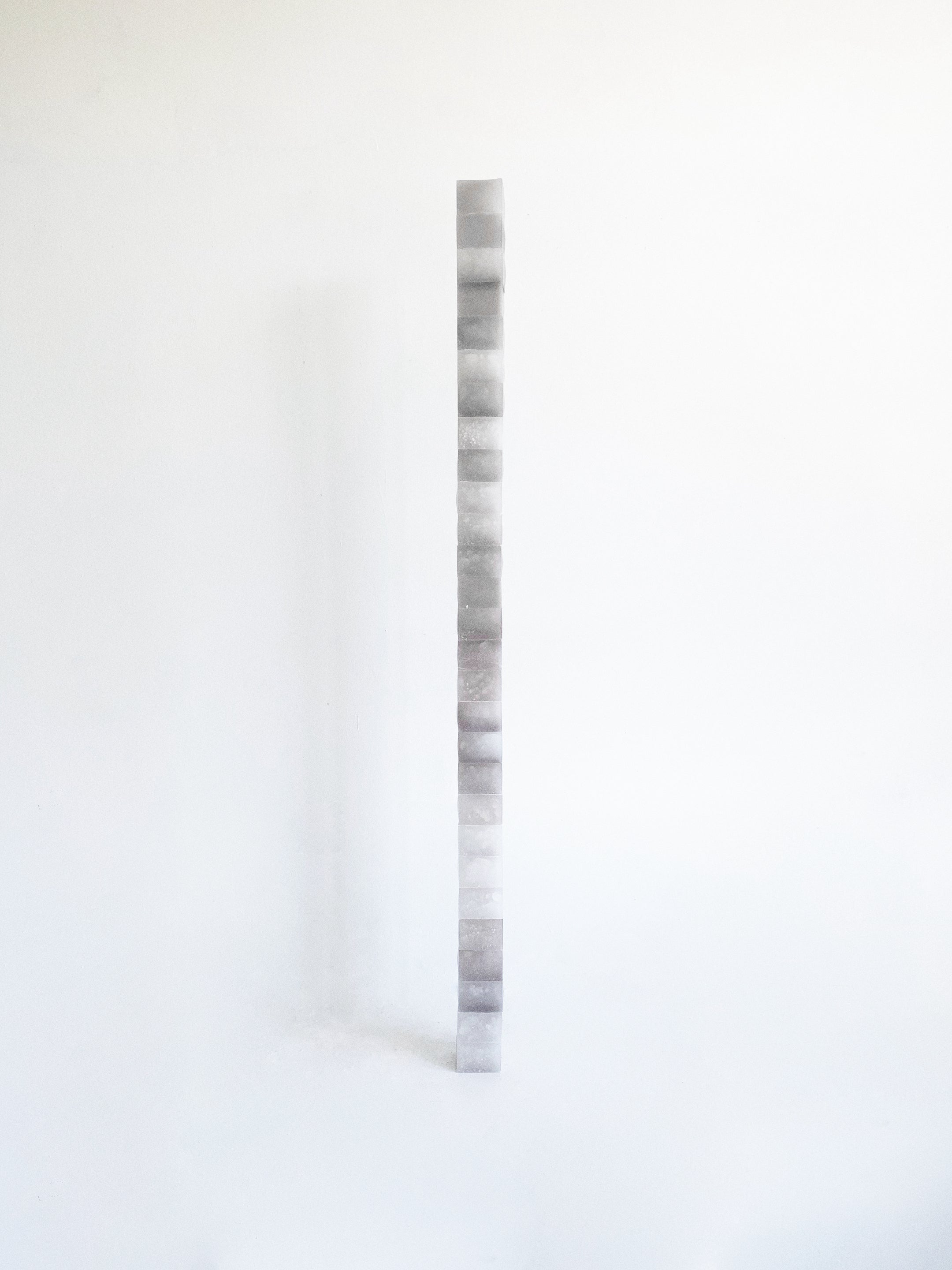 A stack of grey tone wax cube