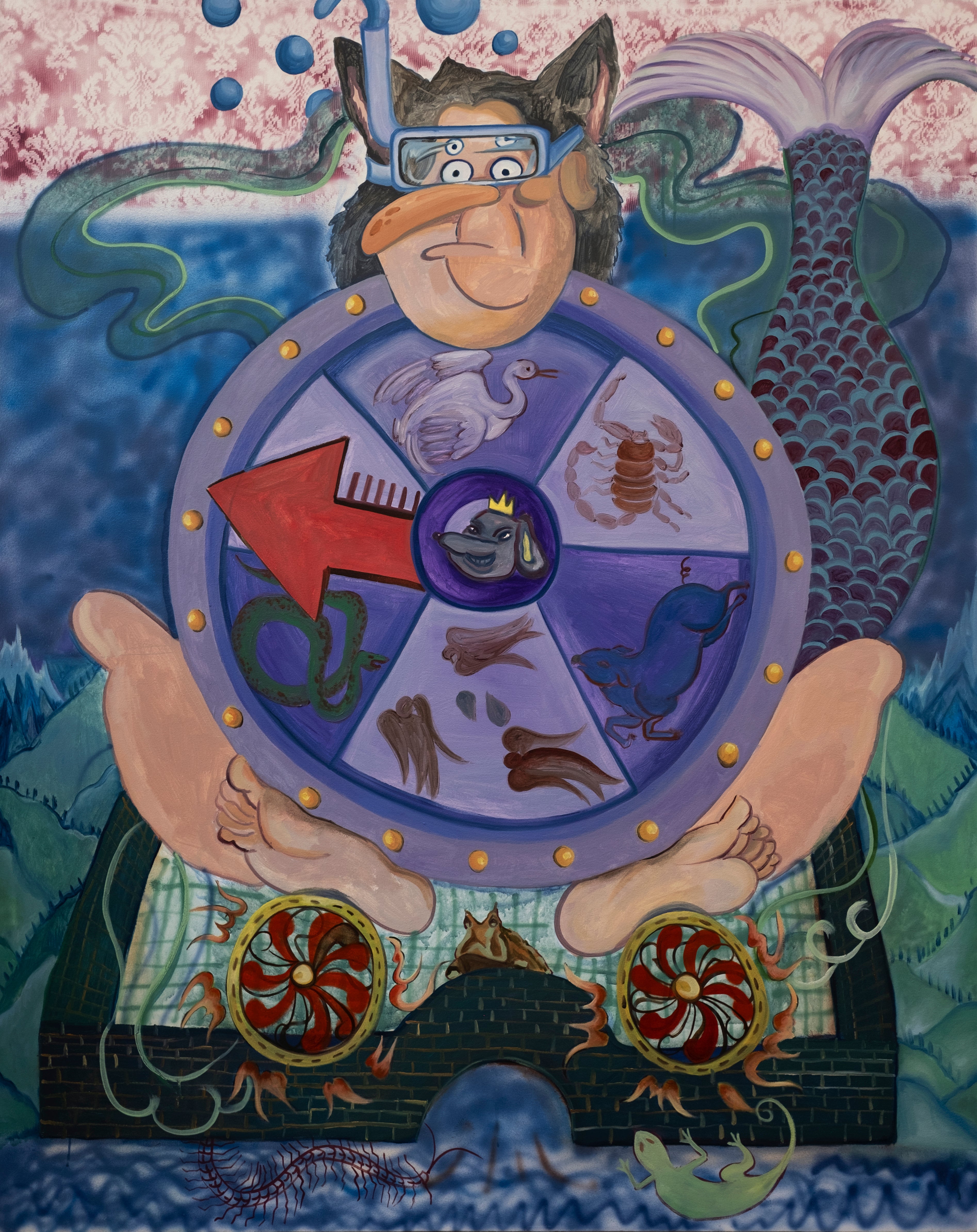 A man with a spinning wheel sitting in a small city.