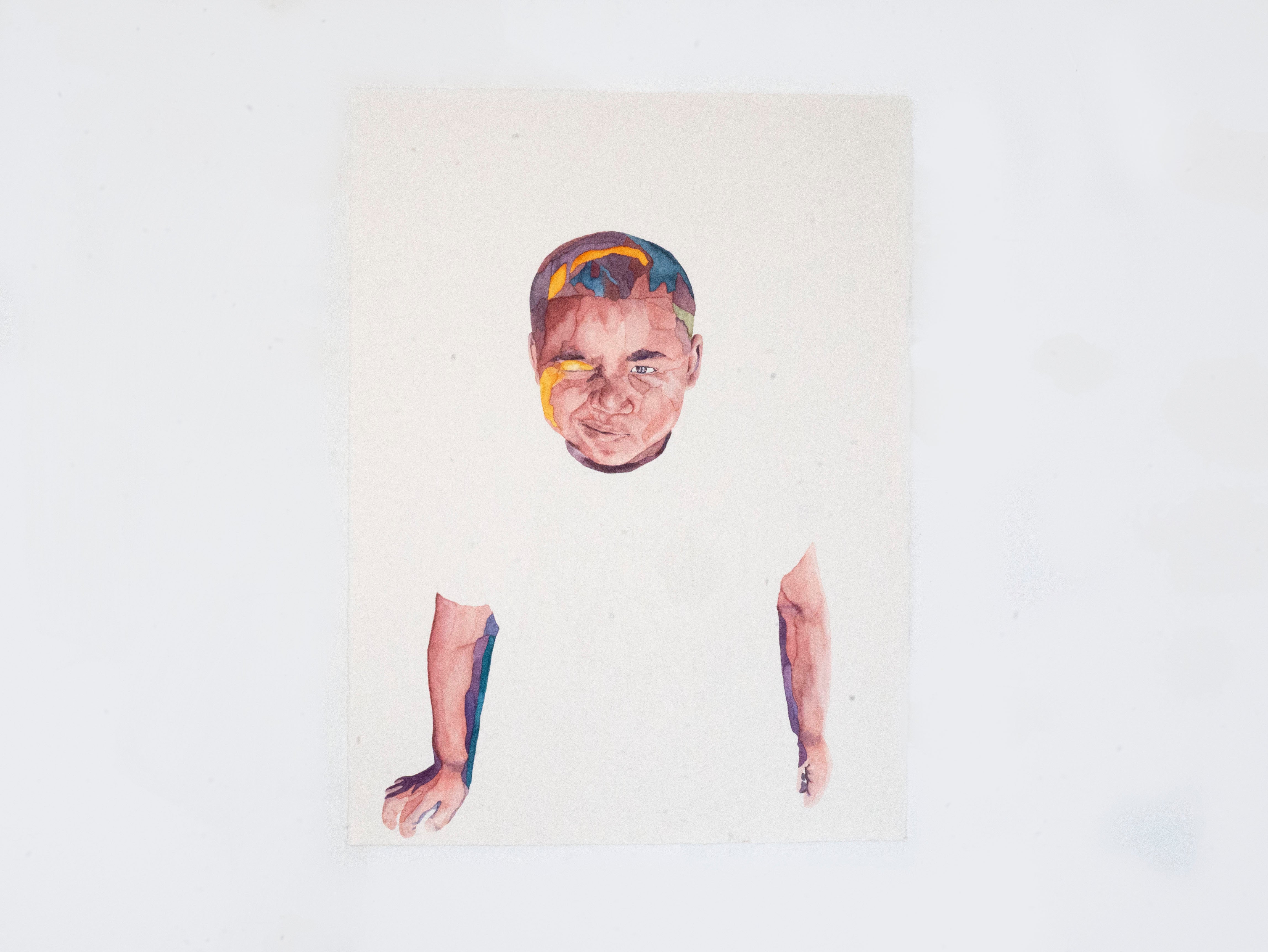 Portrait of a young boy making a winking face.