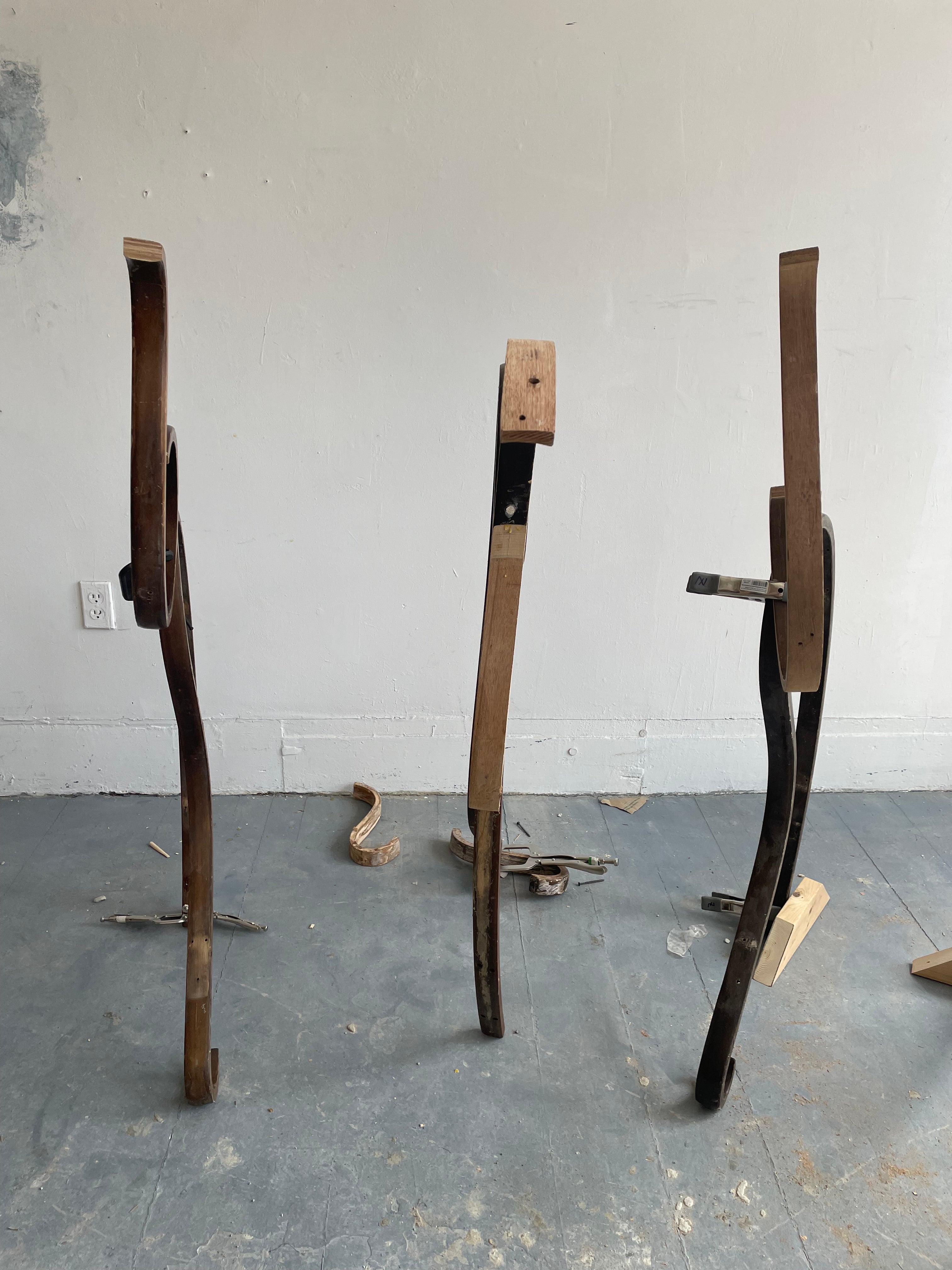Pieces of old rocking chairs reconnected to stand straight up but crooked and bendy.