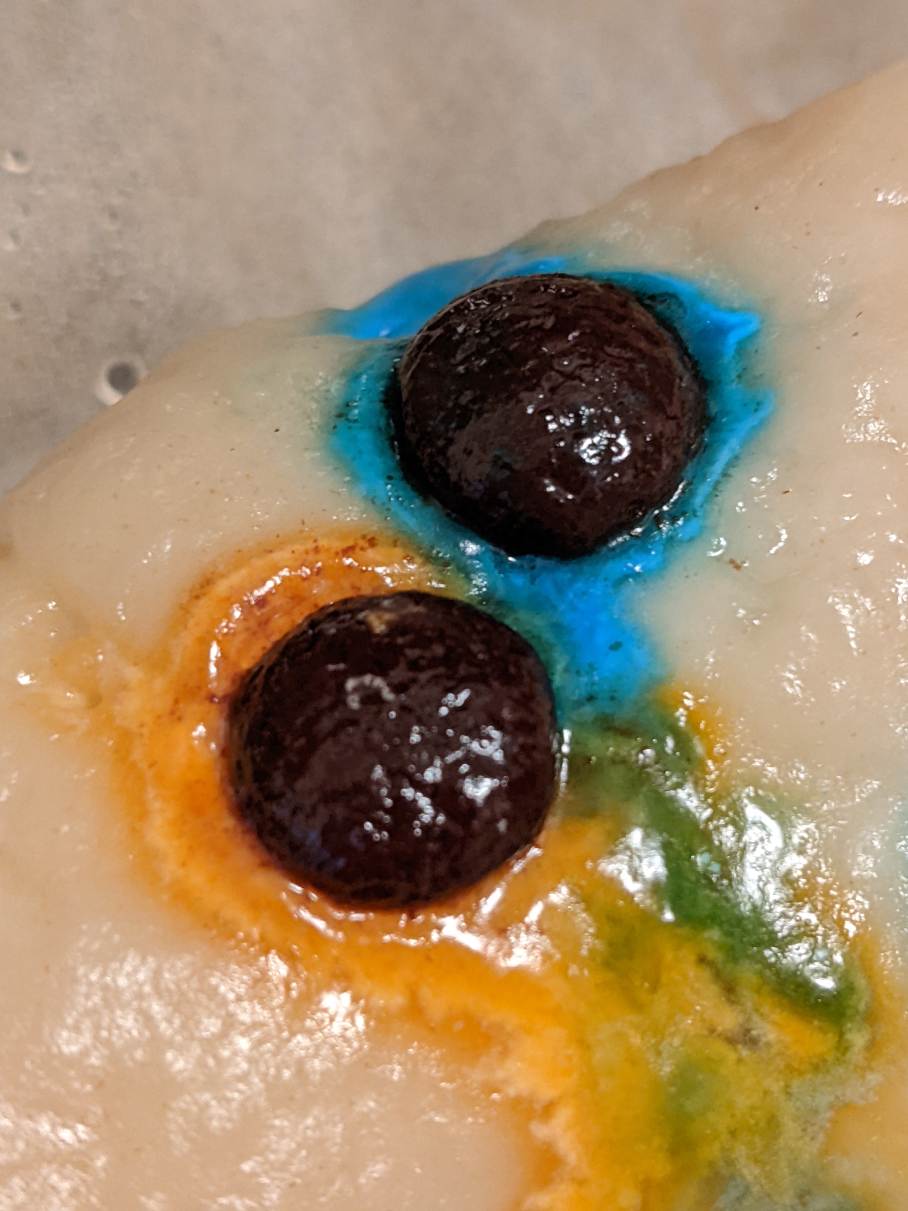 Colorful melted candies on top of steamed flour dough