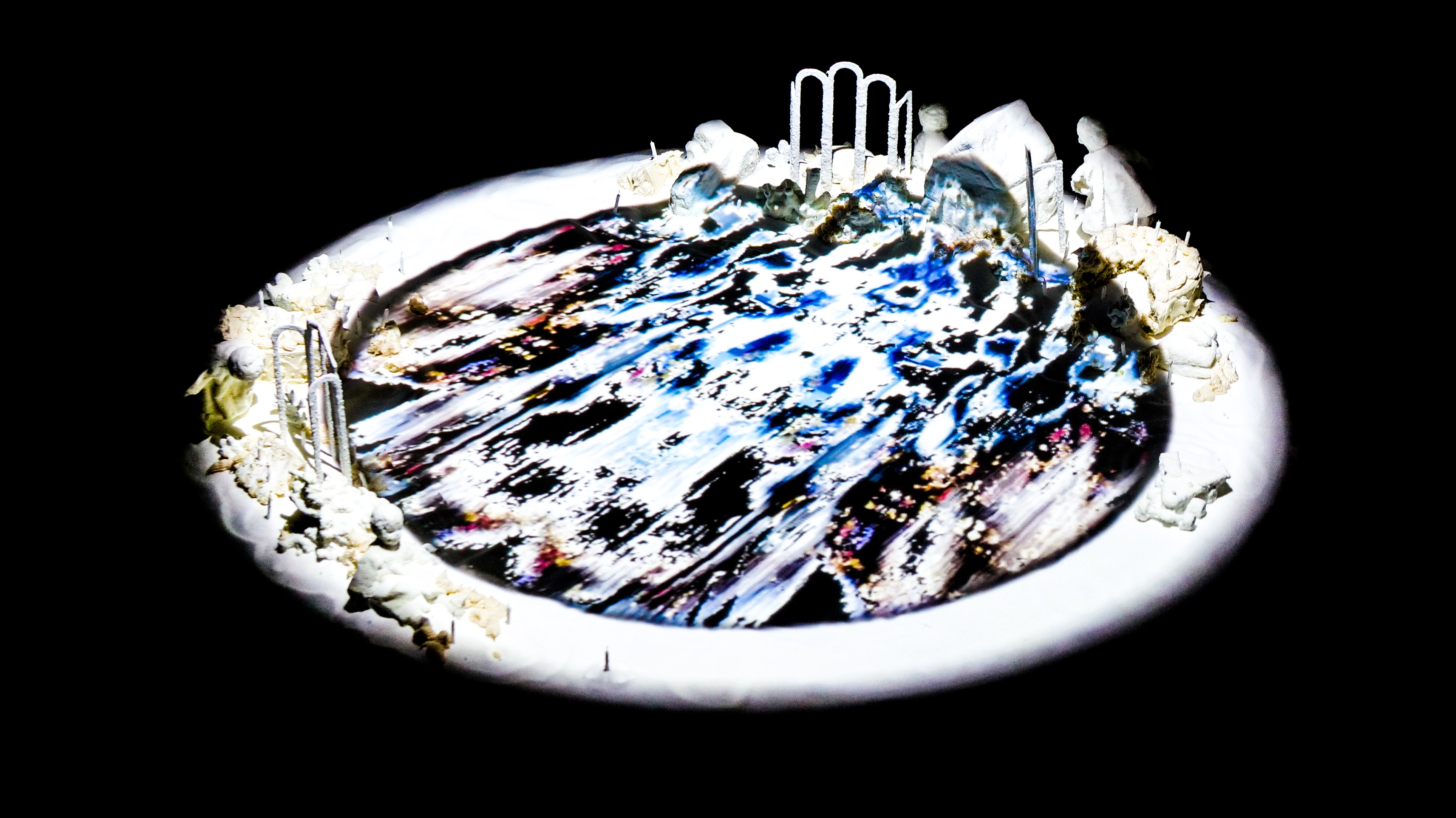 Photogrammetry animation projection installation on pool of salt figurines and birthday cake