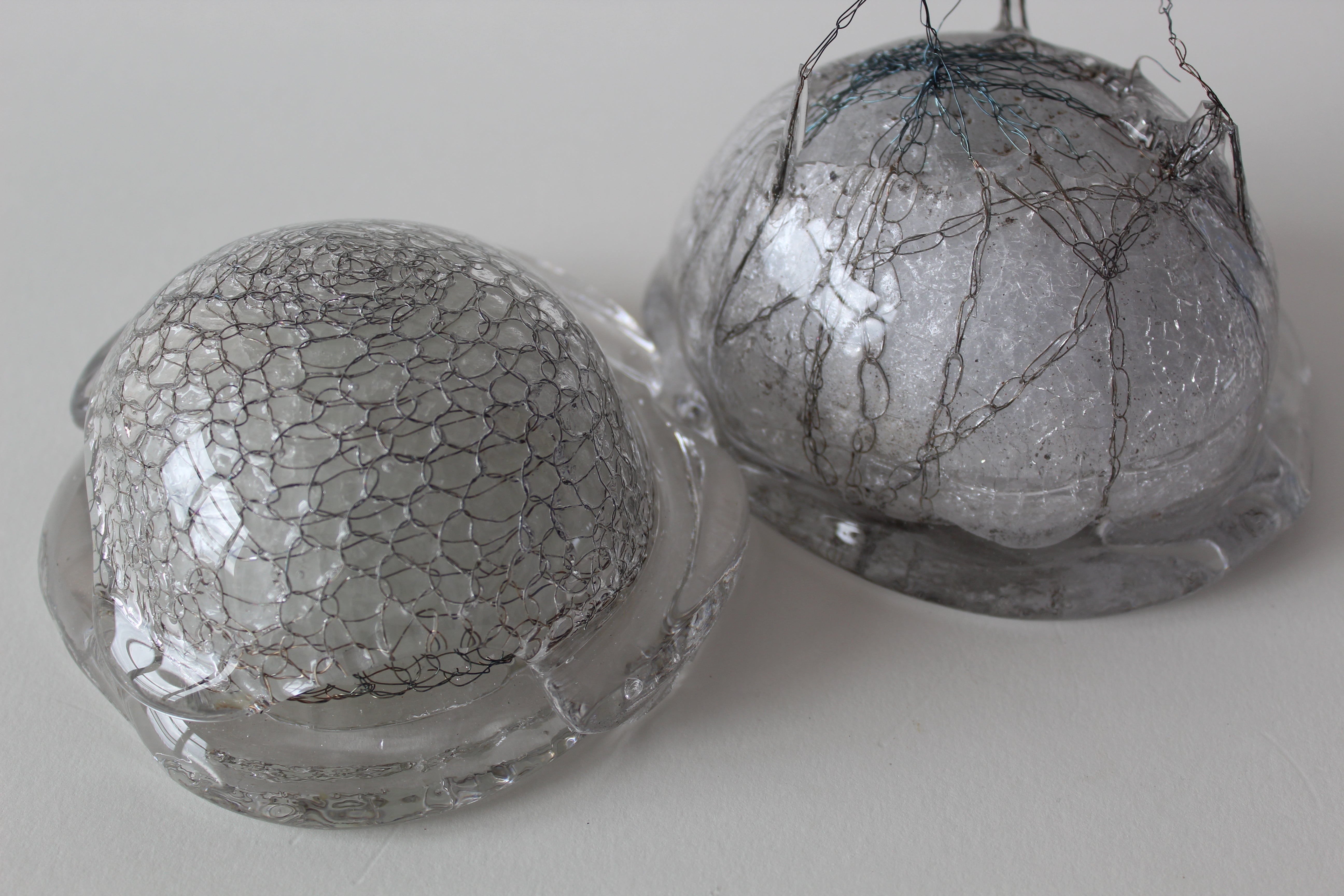 Two glass objects in the shape of half domes.
