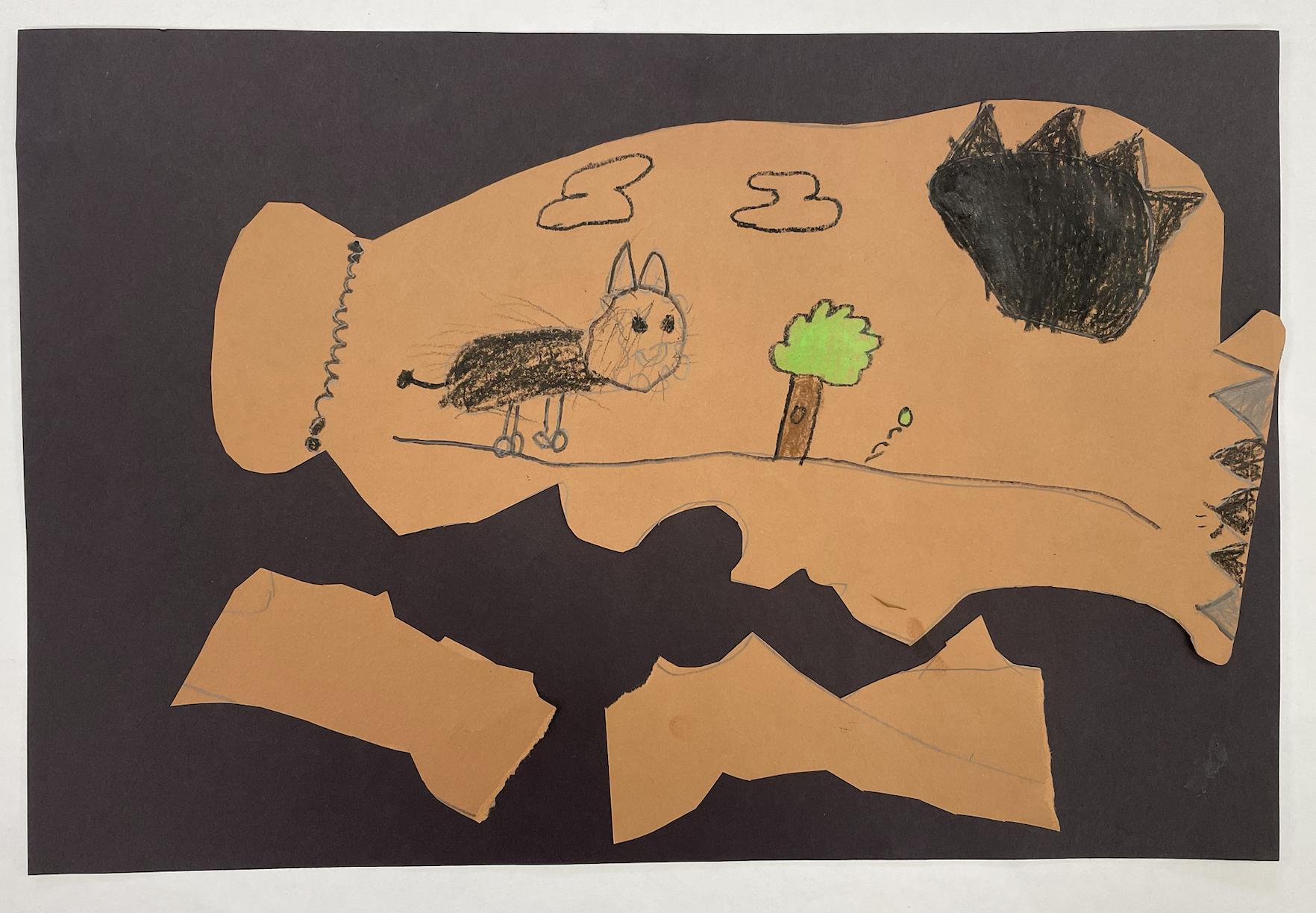 Image of student artwork. Student turned paper sideways to show a vase that has fallen over. The image shows a dog playing with a tennis ball.