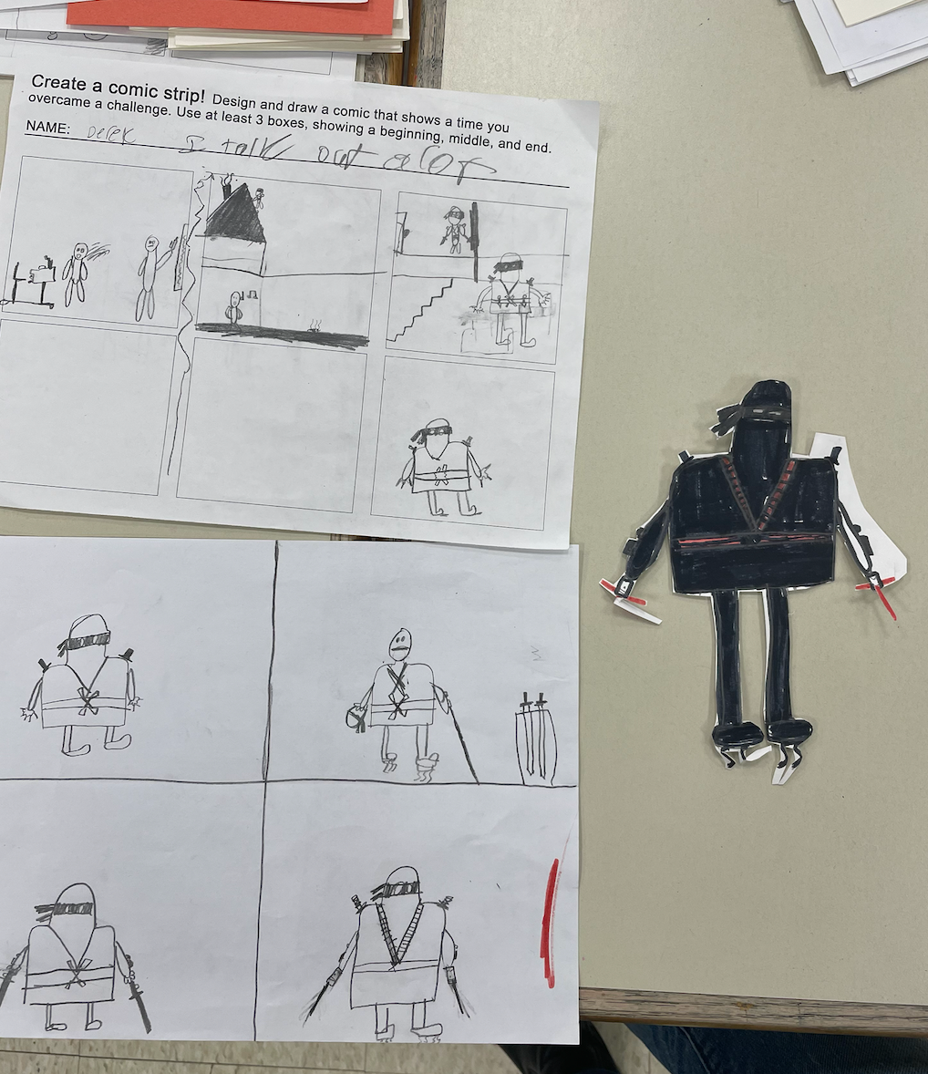 Student work on table, shows process of planning, sketching, and creating. 
