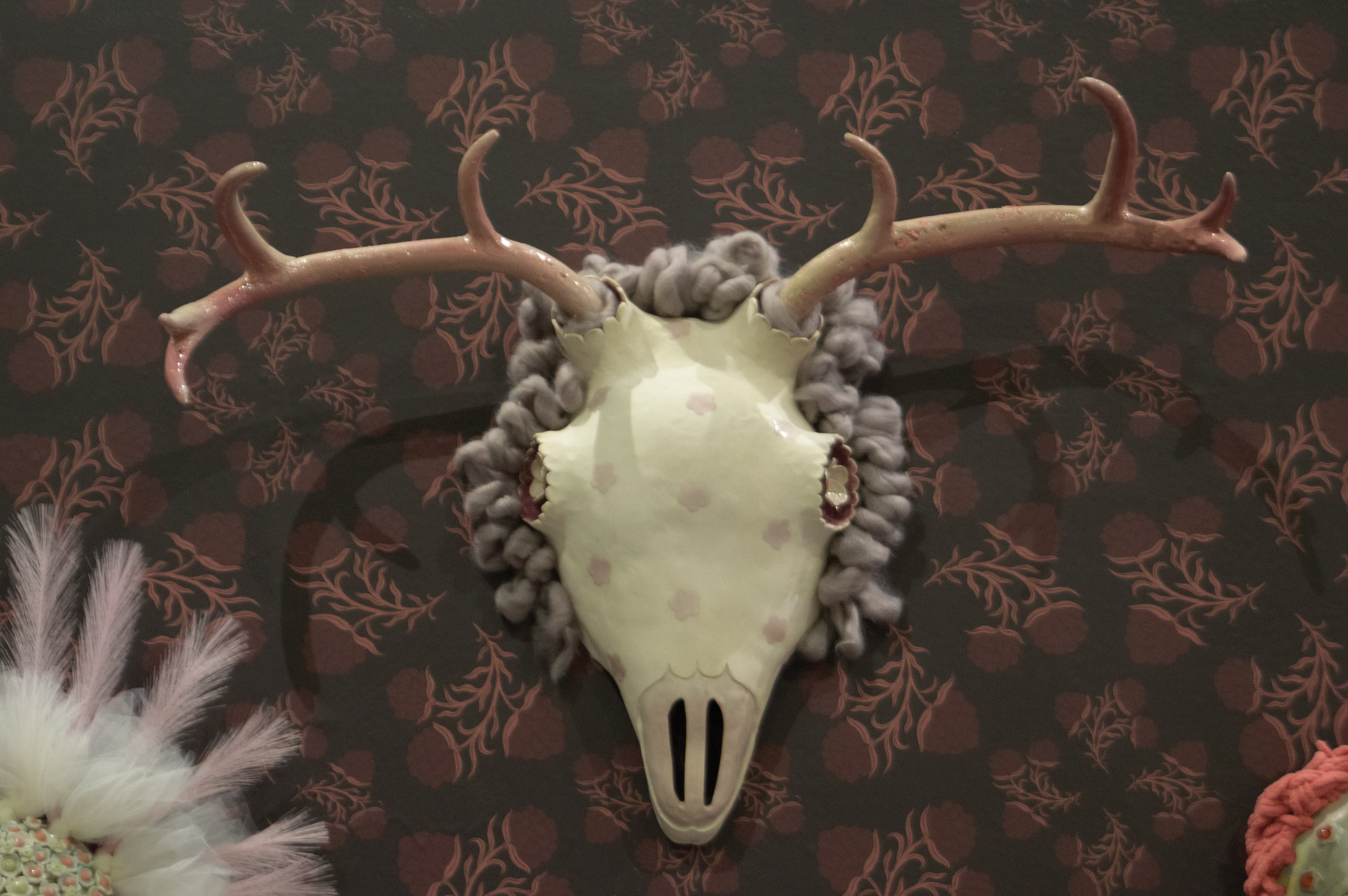 Ceramic mask of skull and antlers.