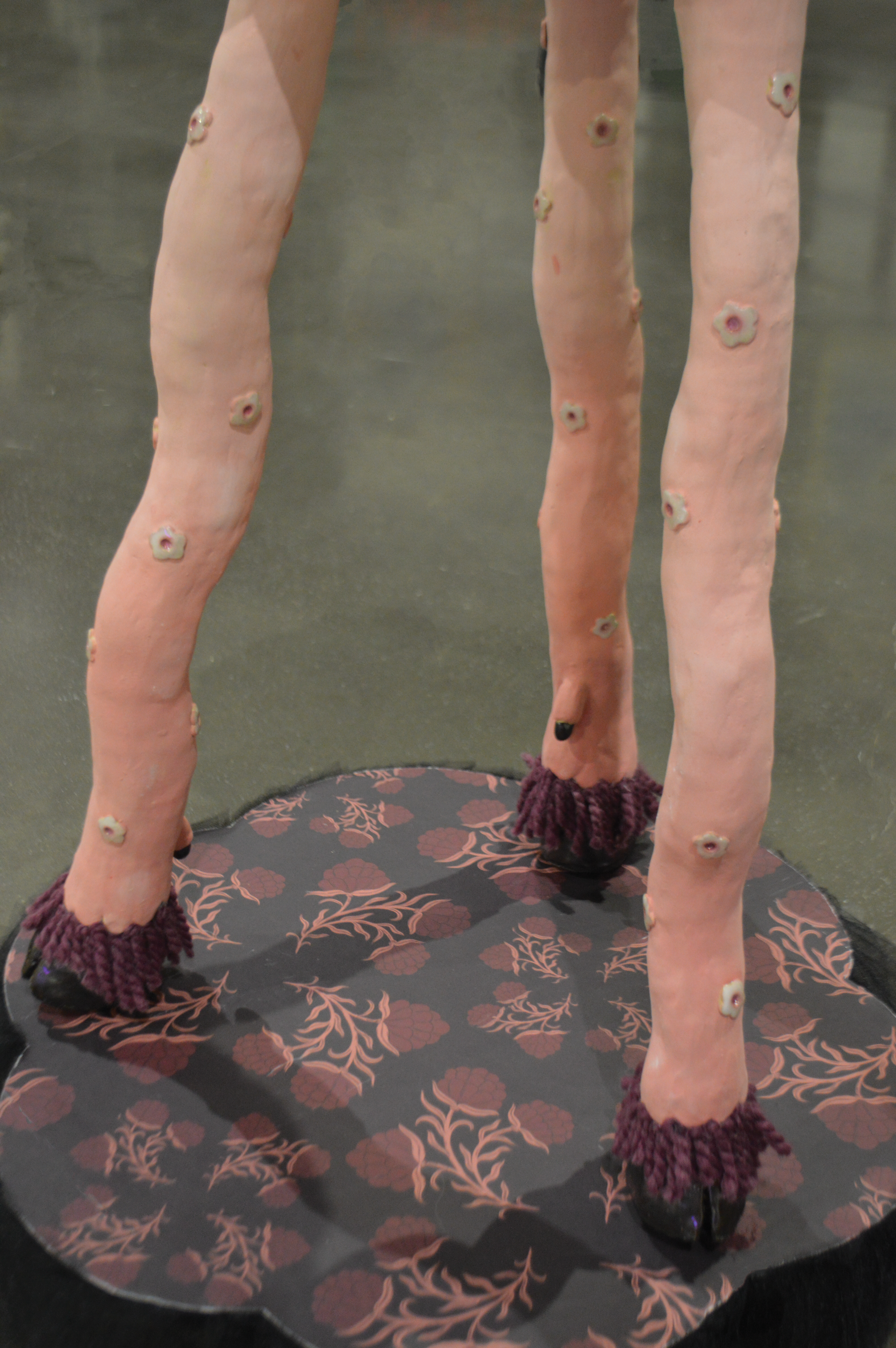 Wavy pink ceramic table legs with hooves.