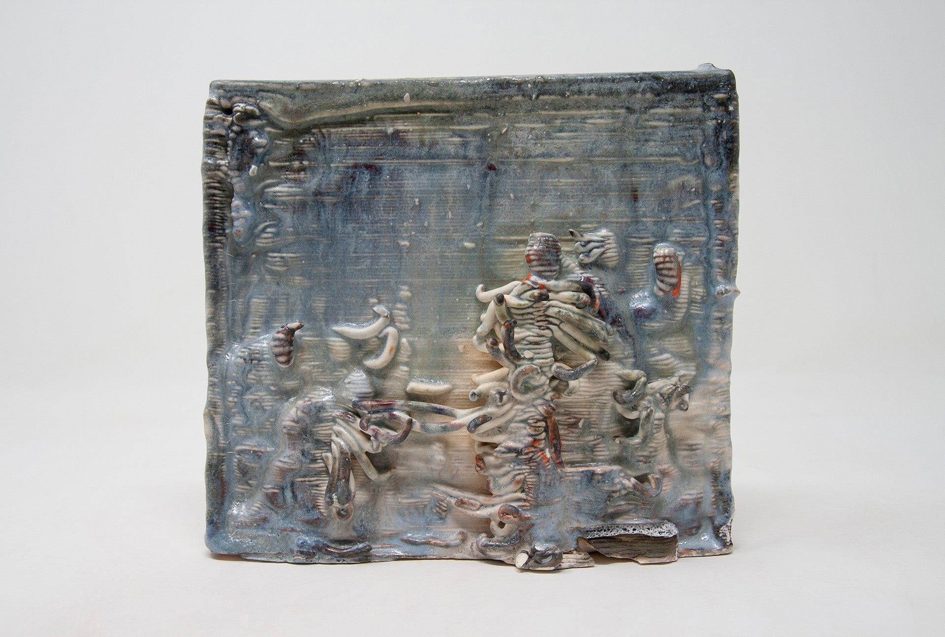 Blue-glazed ceramic tile scene of 5 abstract figures