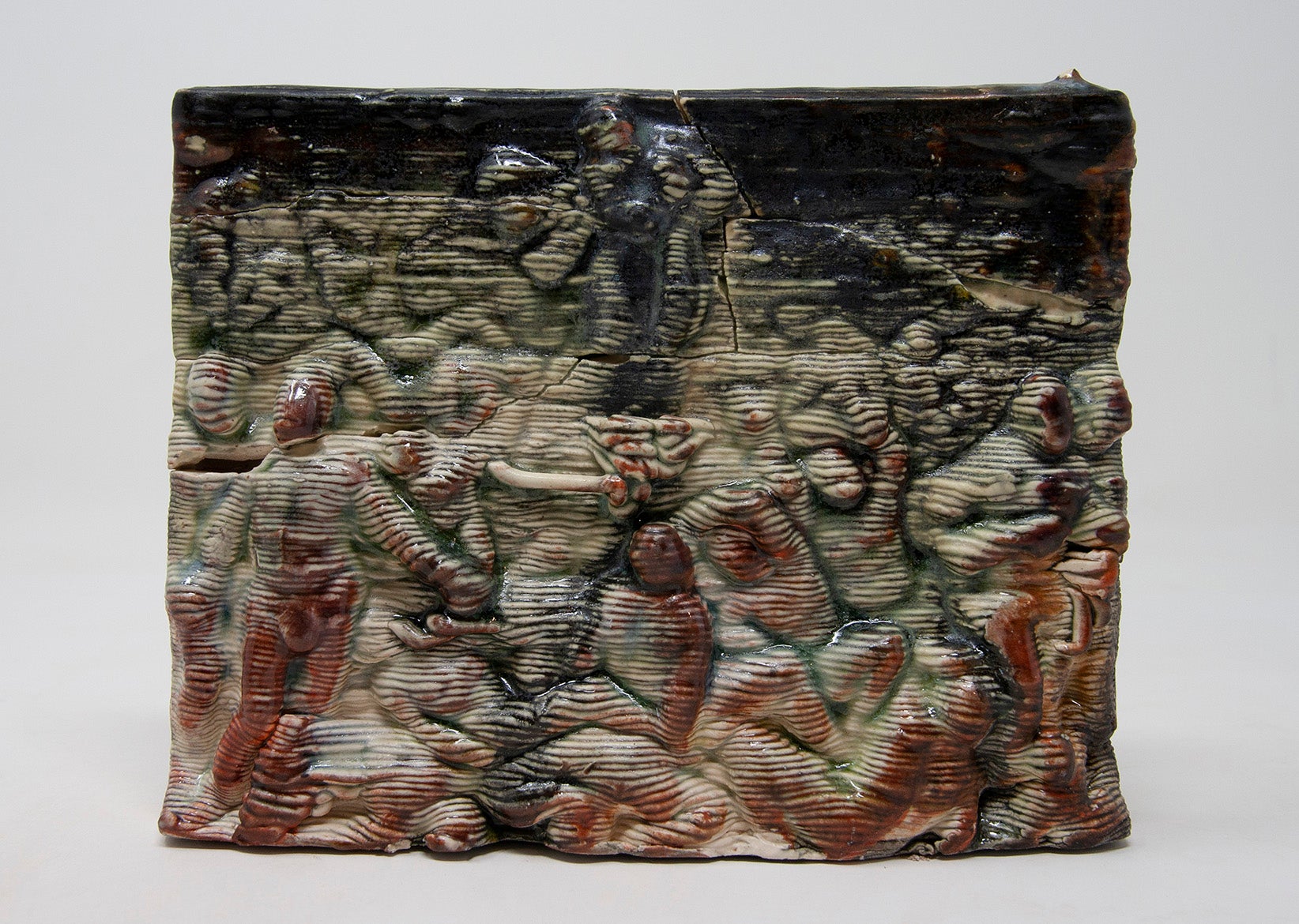 Black and red glazed ceramic tile scene showing crowd of people looking towards figure in the sky