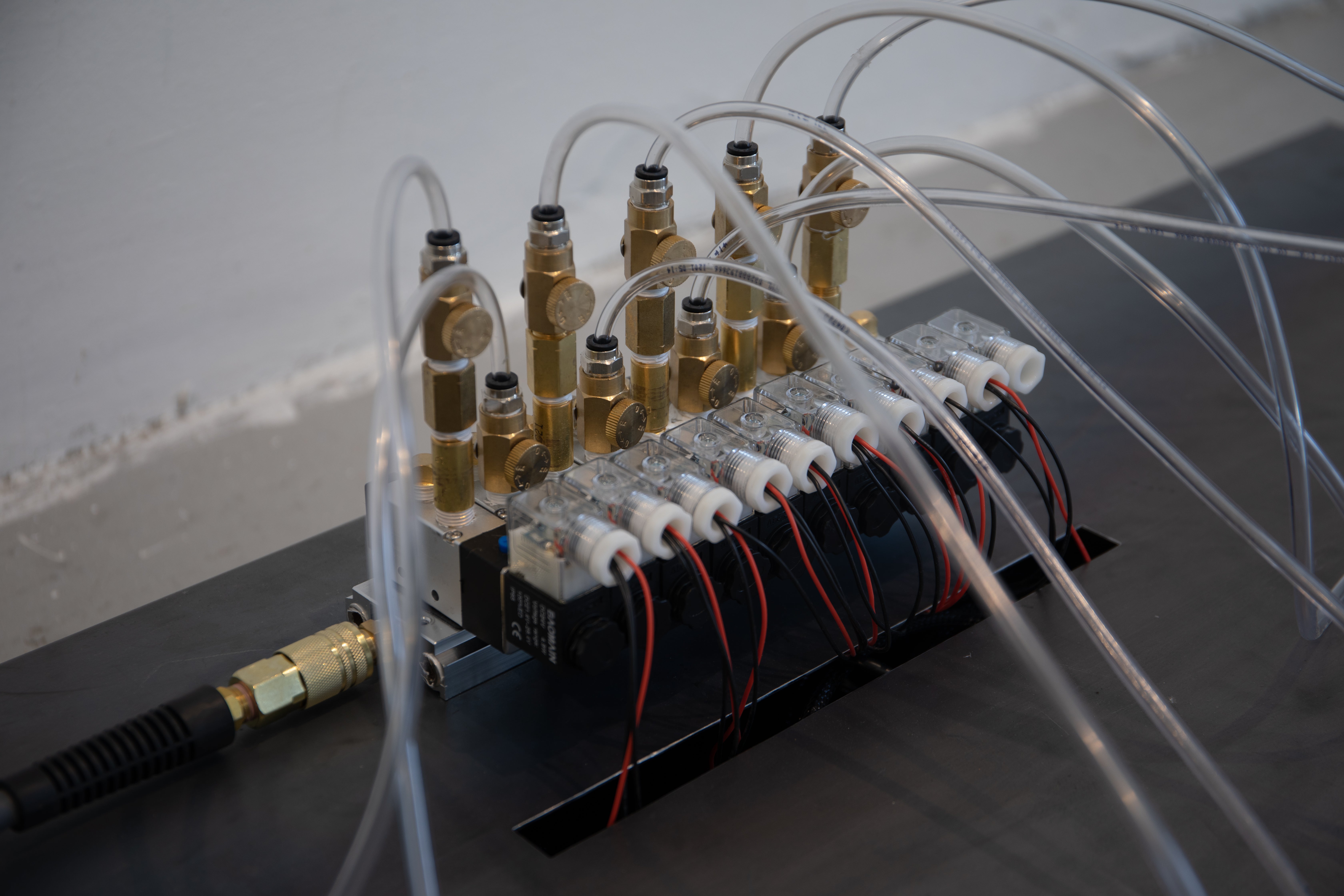 Pneumatic solenoid manifold with vinyl tubing.