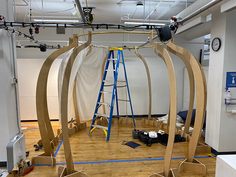 A spherical space created by curved wooden pieces standing eight feet tall connected with a metal ring at the top