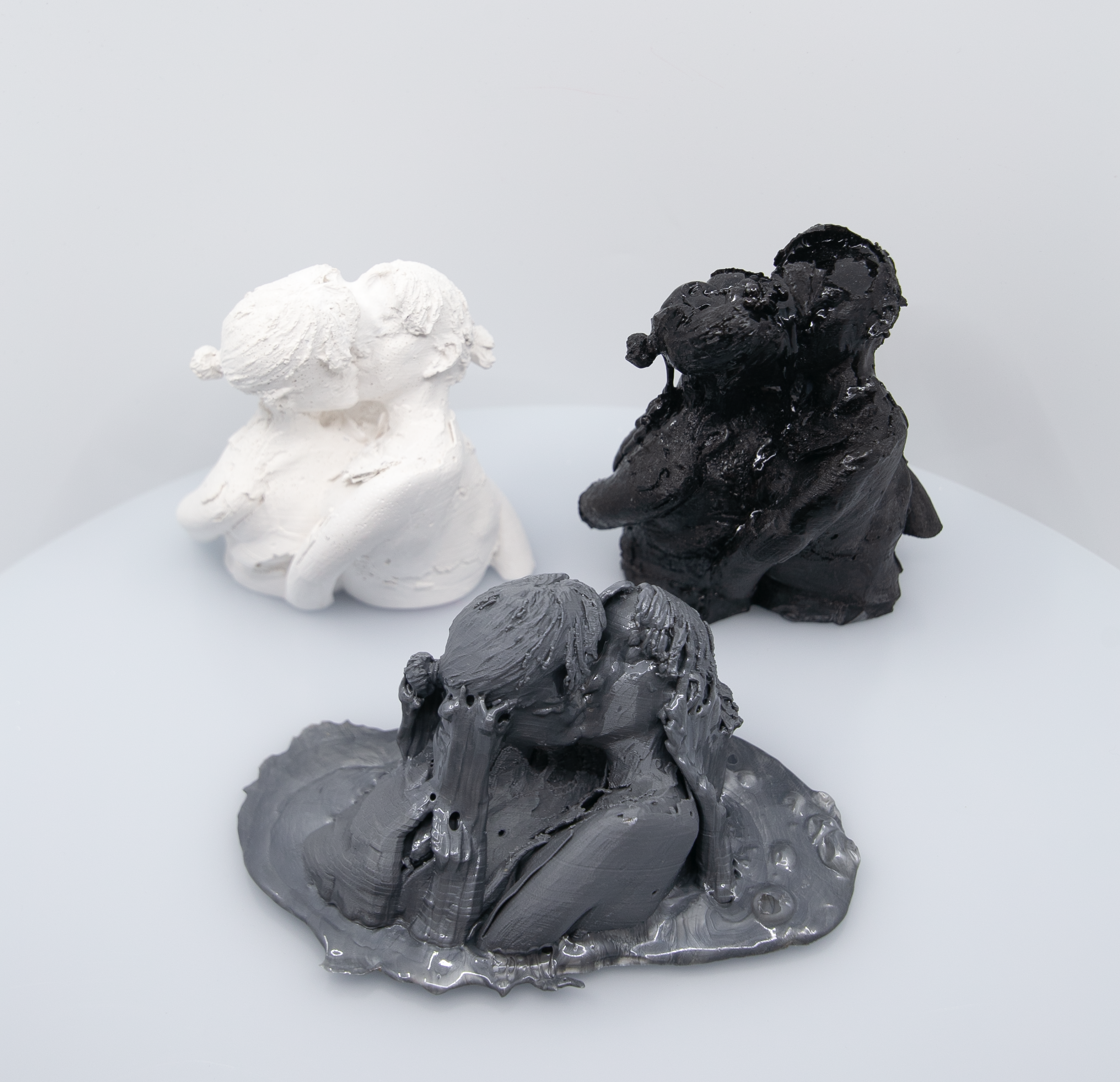 Multiple images of different small sculptures of varying materials flash on screen.