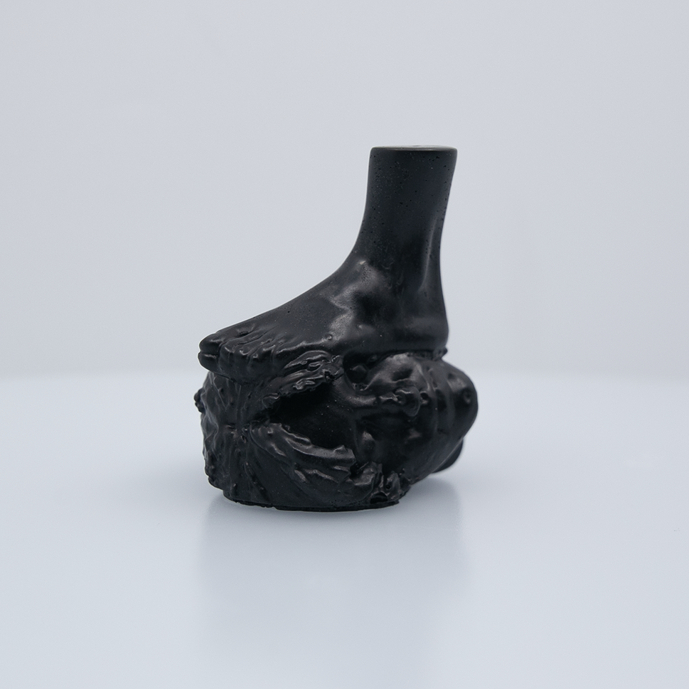 A black figure of a foot stepping on a face.