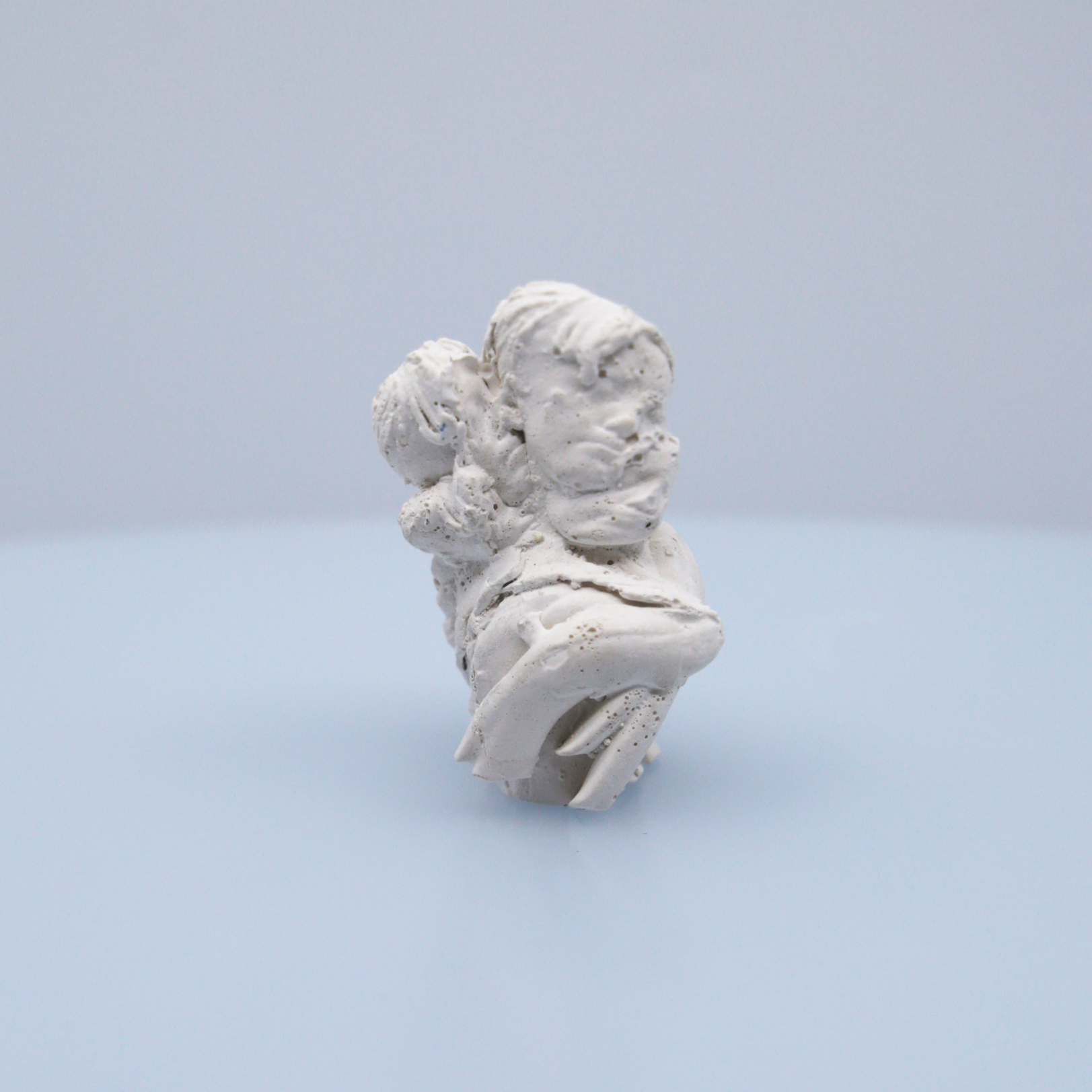 A small white figure with multiple heads.