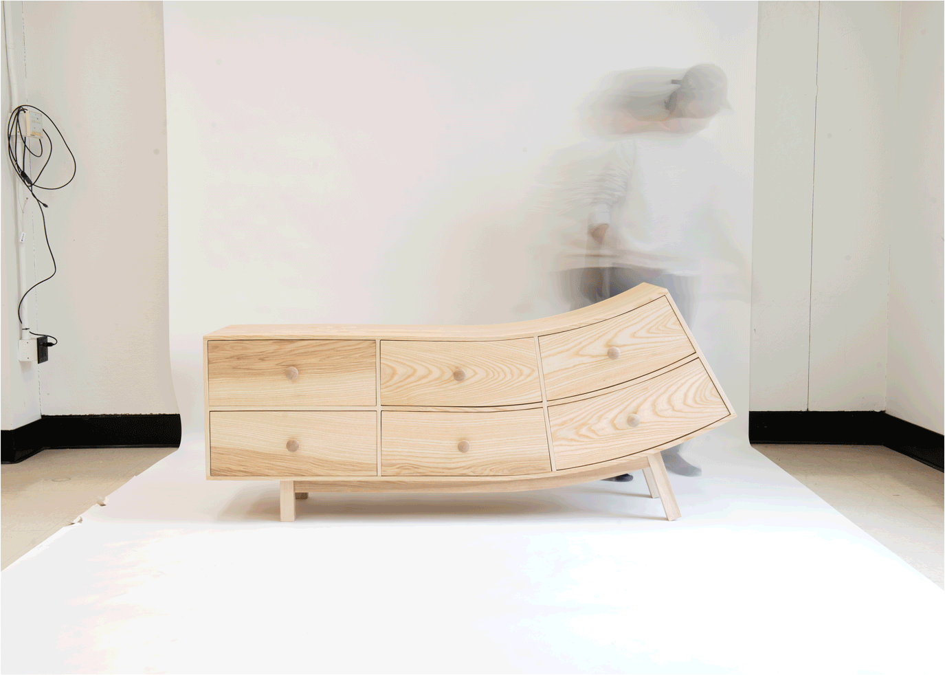GIF of the artist moving around bent dresser