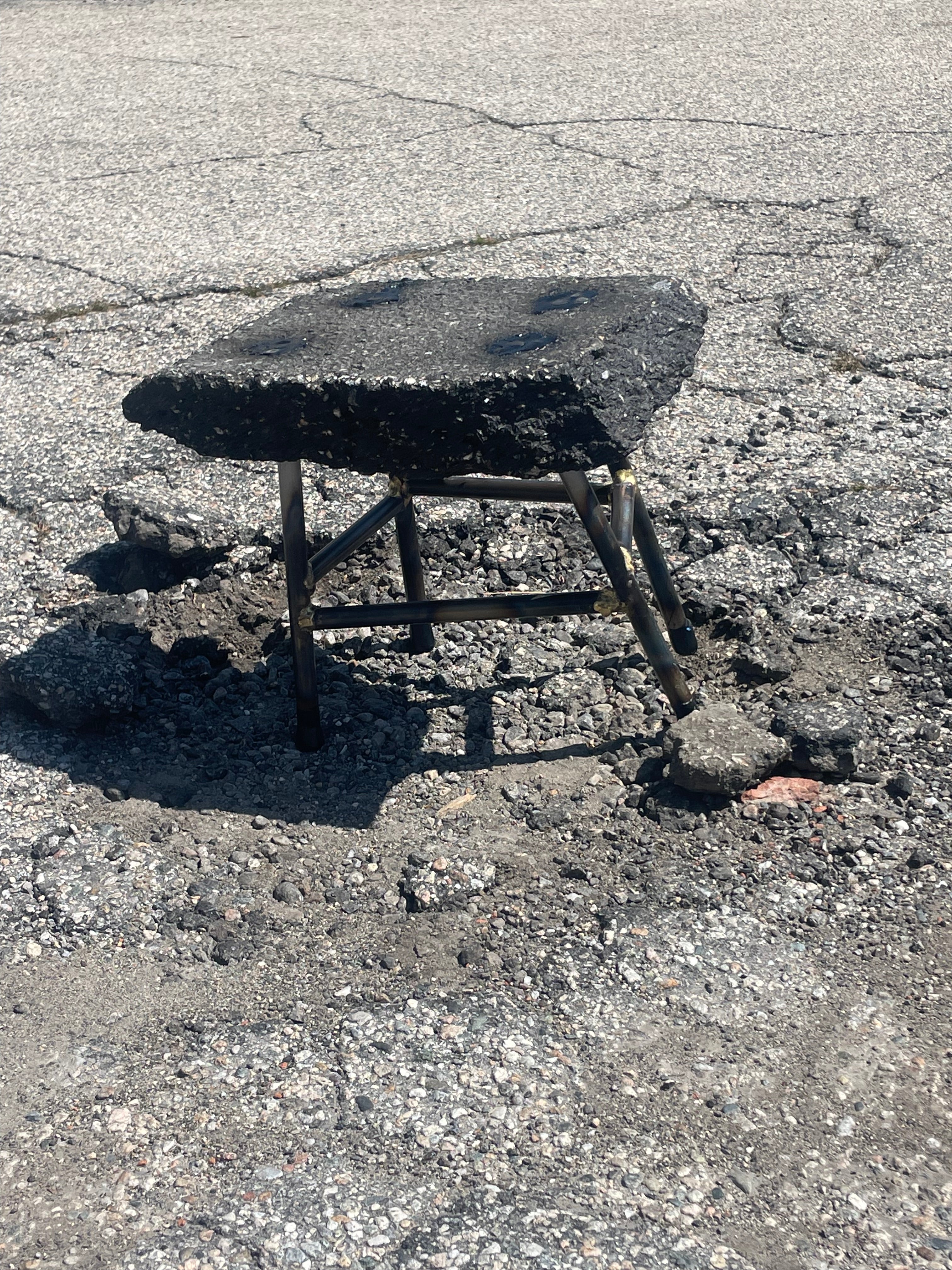 Asphalt stool on damaged roadway