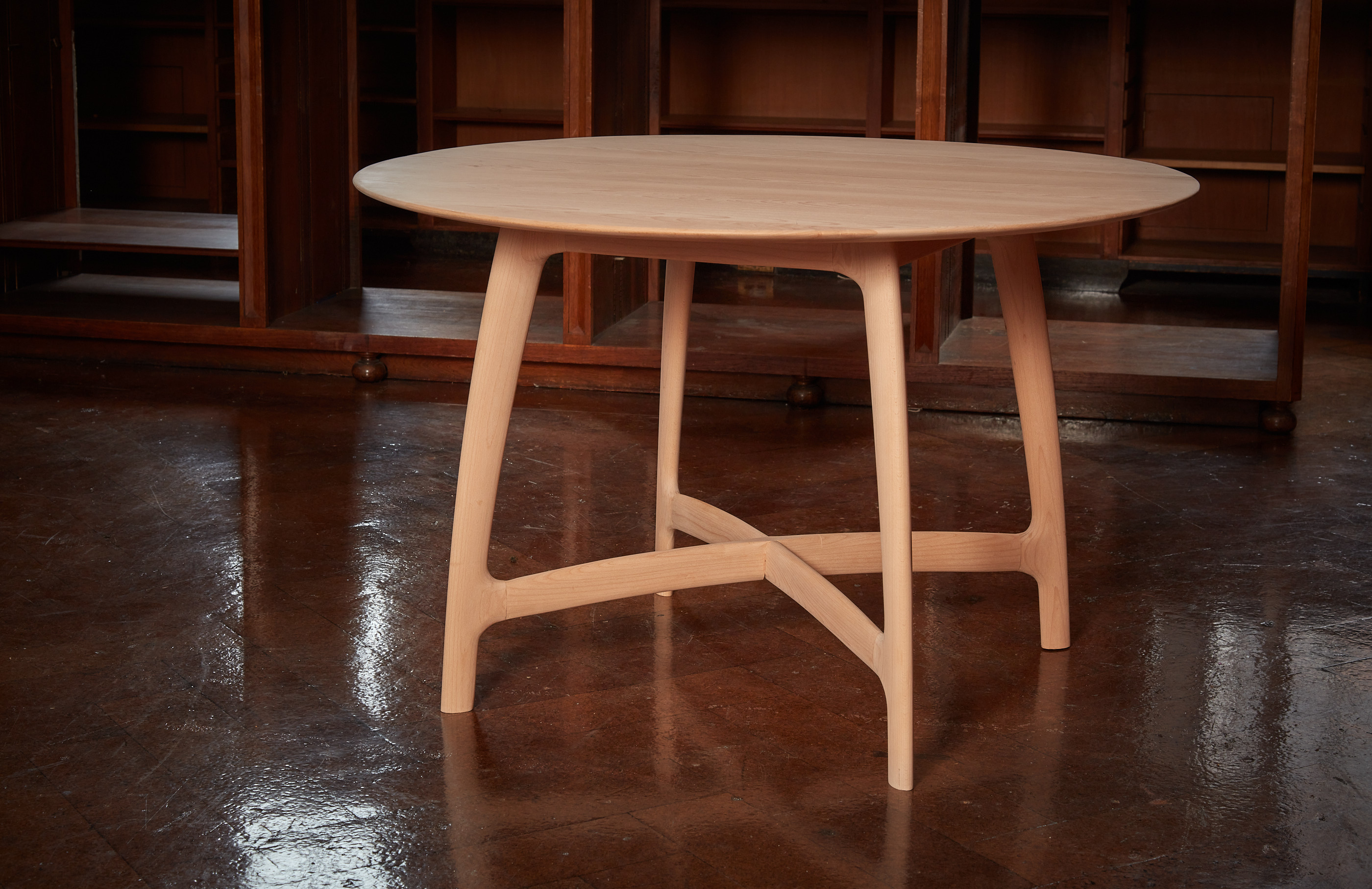 Beech wood dining table with library background