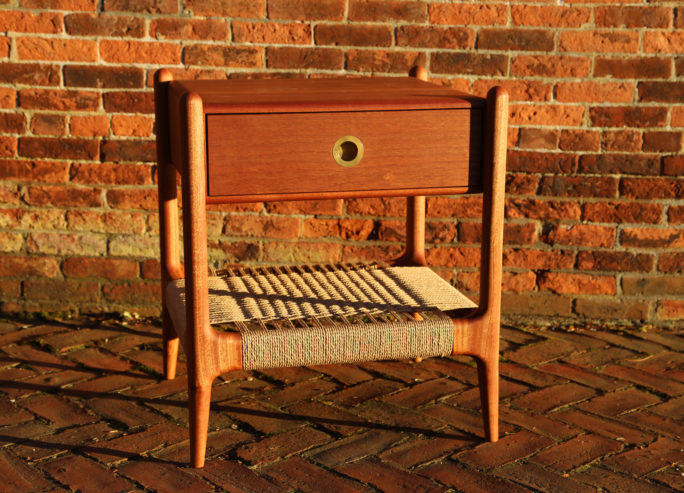 Sapele wood nightstand with brick background
