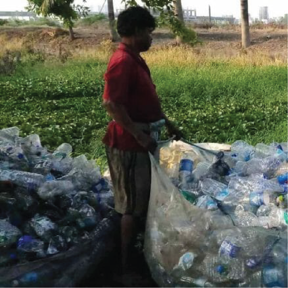 Kabadiwala sorting through garbage which is later sold to a bulk buyer.