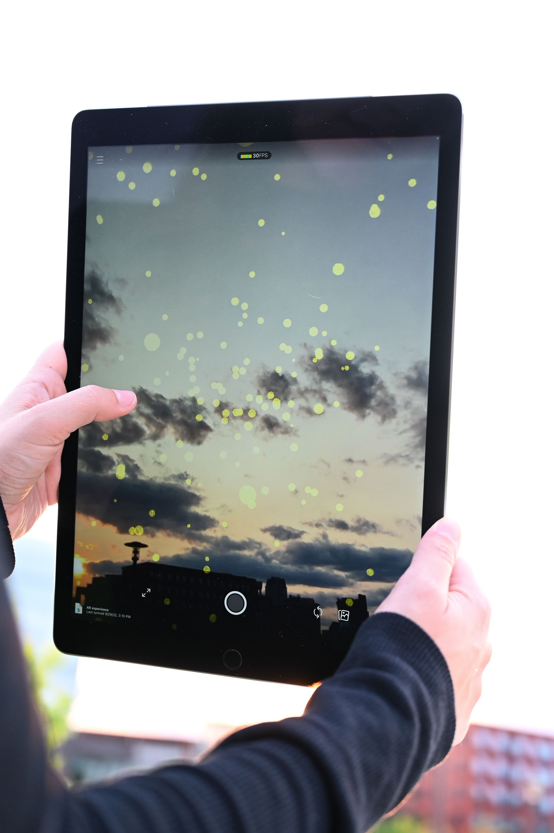 A person using app to create VR fireflies in Providence, R.I.