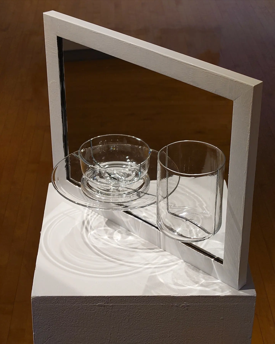 Front side of a mirror with halved hand-blown vessels glued to reference still-life painting.